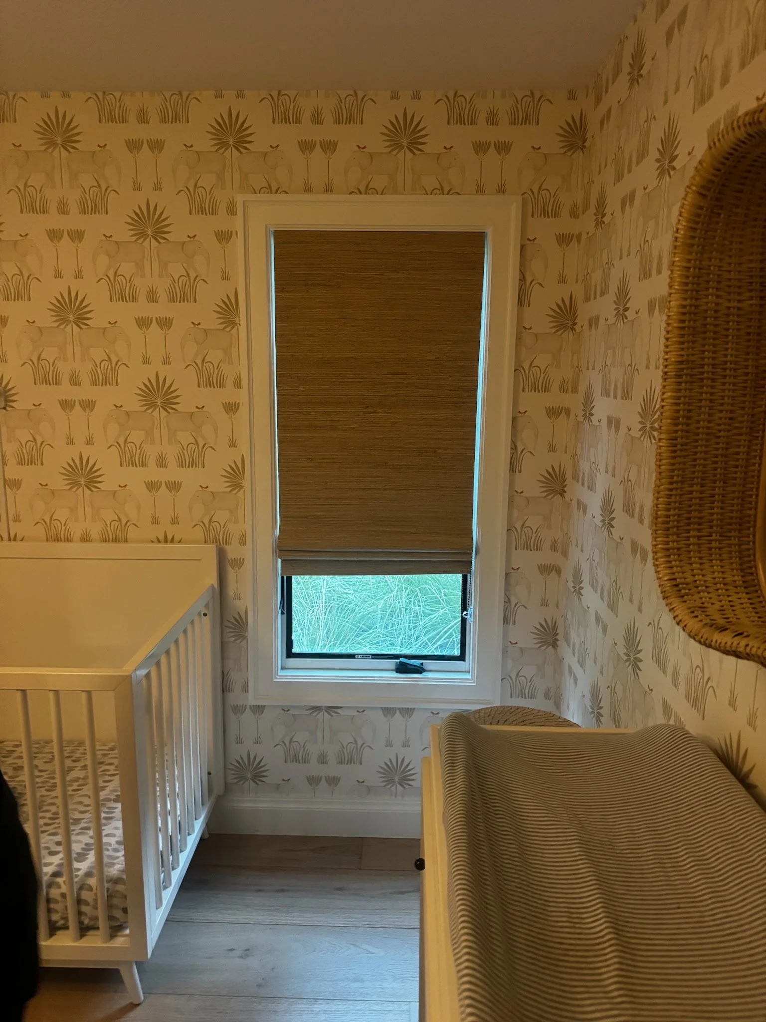 A tan shade at a nursery window.