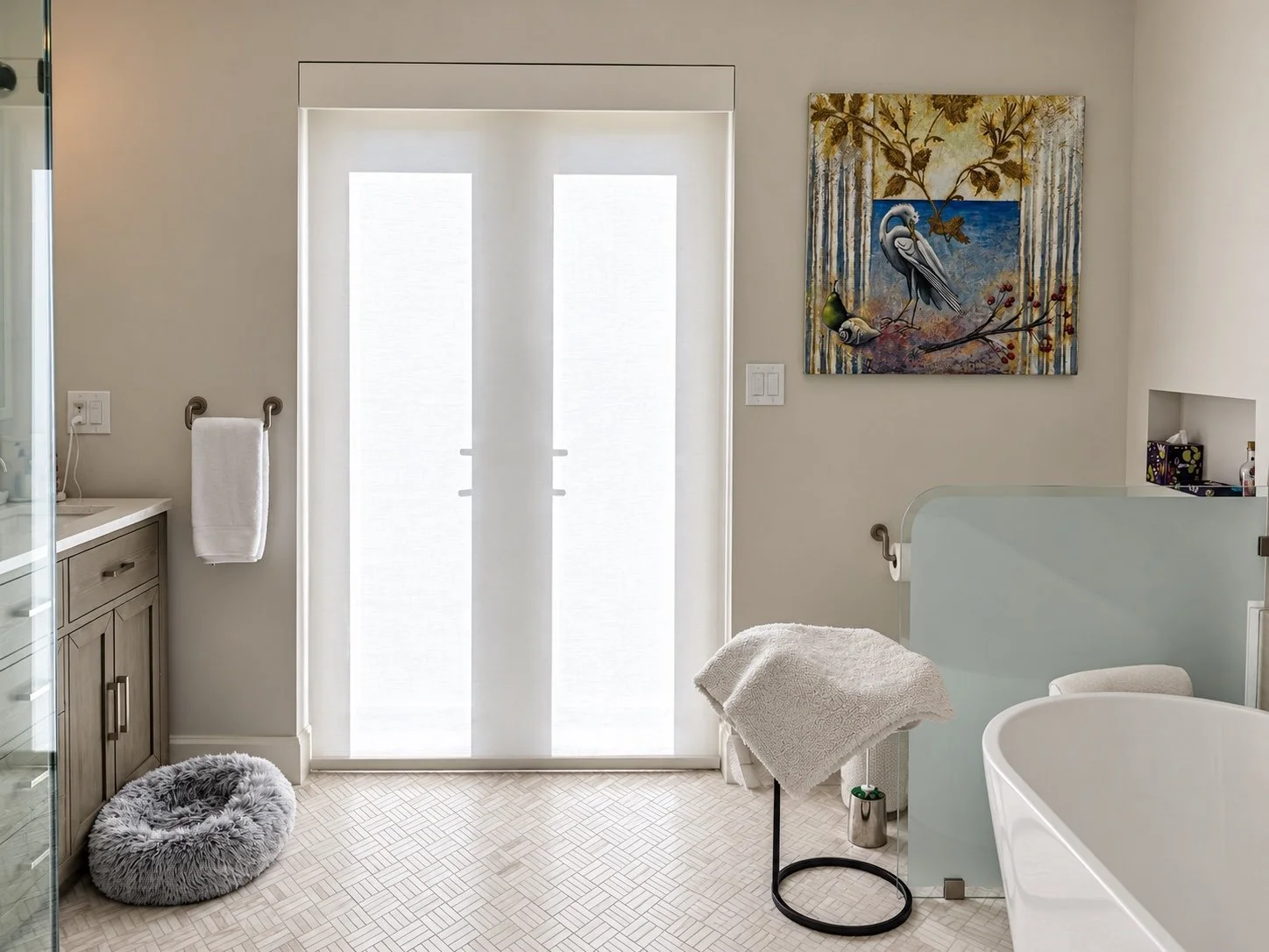 White roller shade covering glass bathroom doors