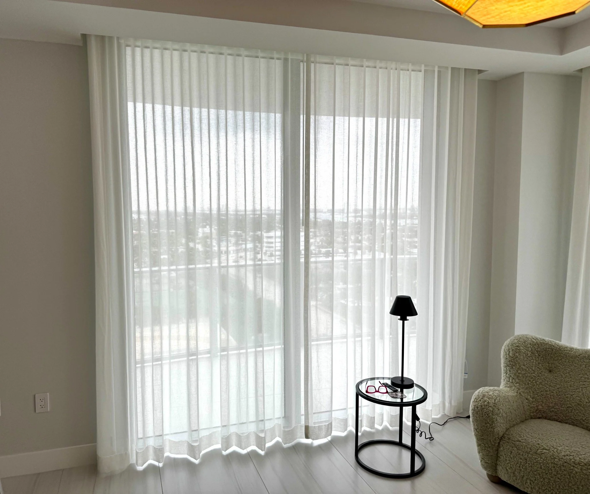 Floor-length sheer drapery softening natural light in a sitting area.