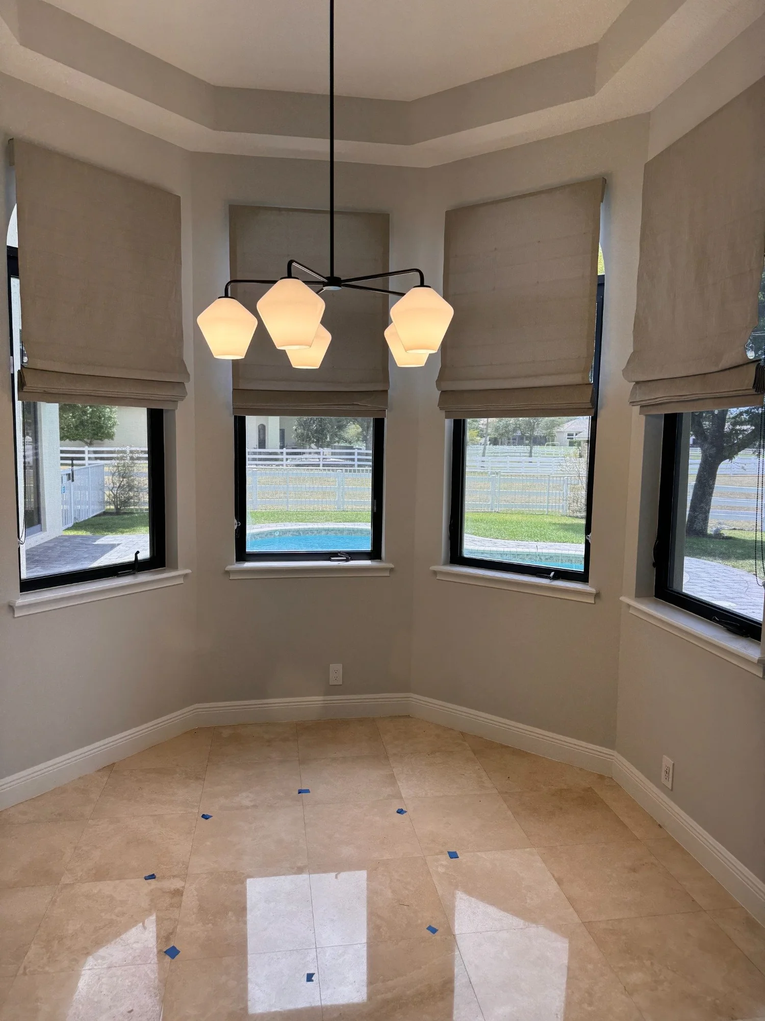 Coordinated Roman shades following a bay window