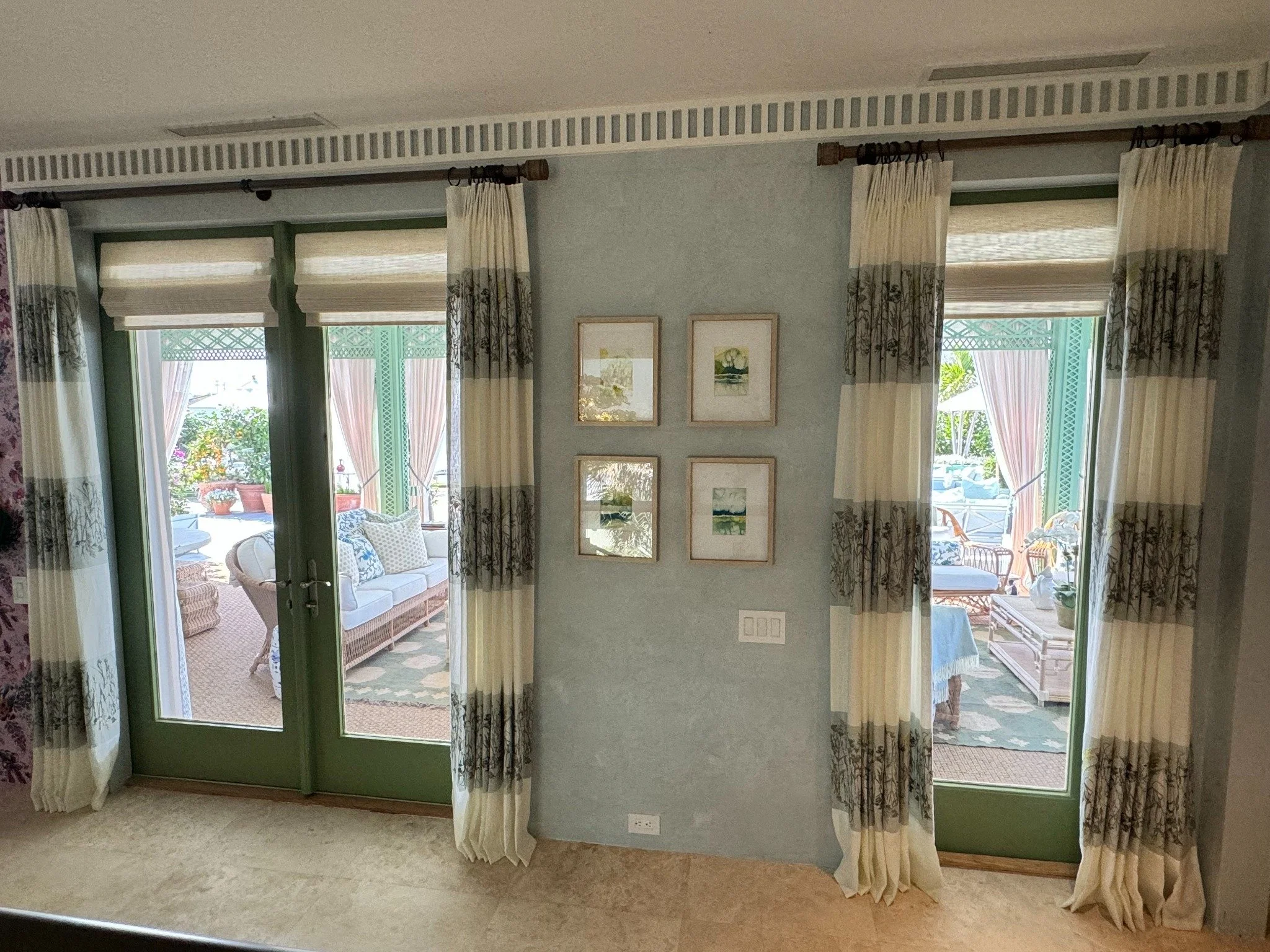 Patterned drapery framing French doors.