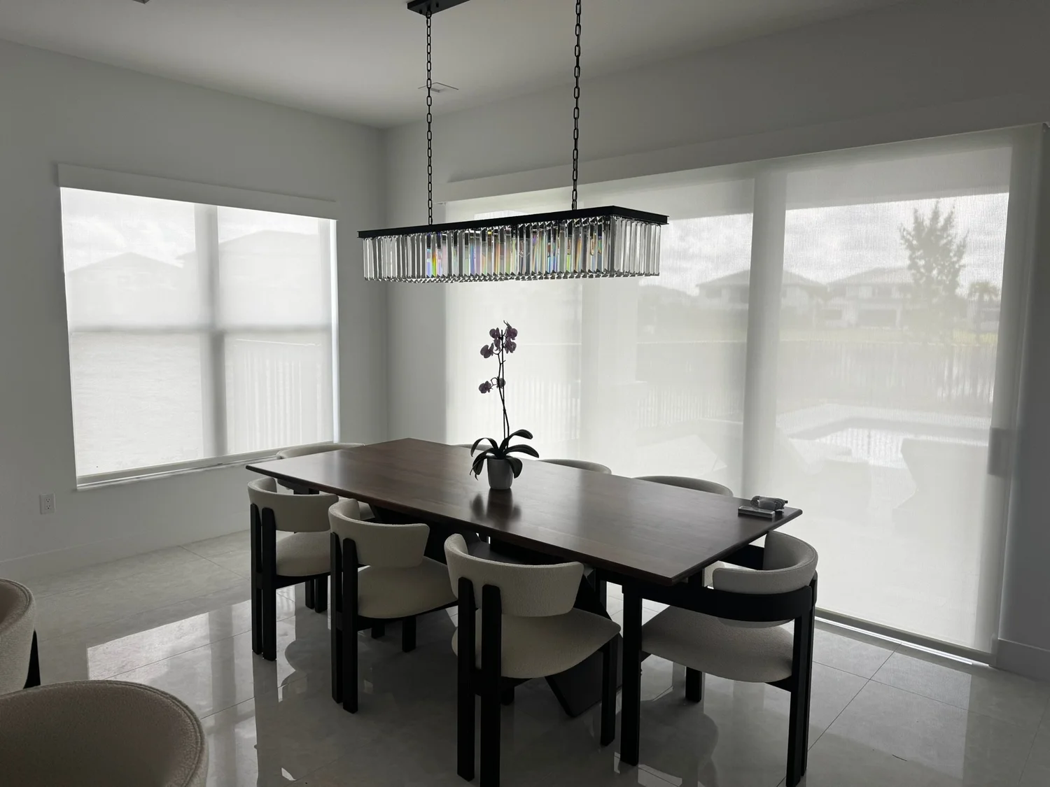 Light-filtering shades surrounding a dining area