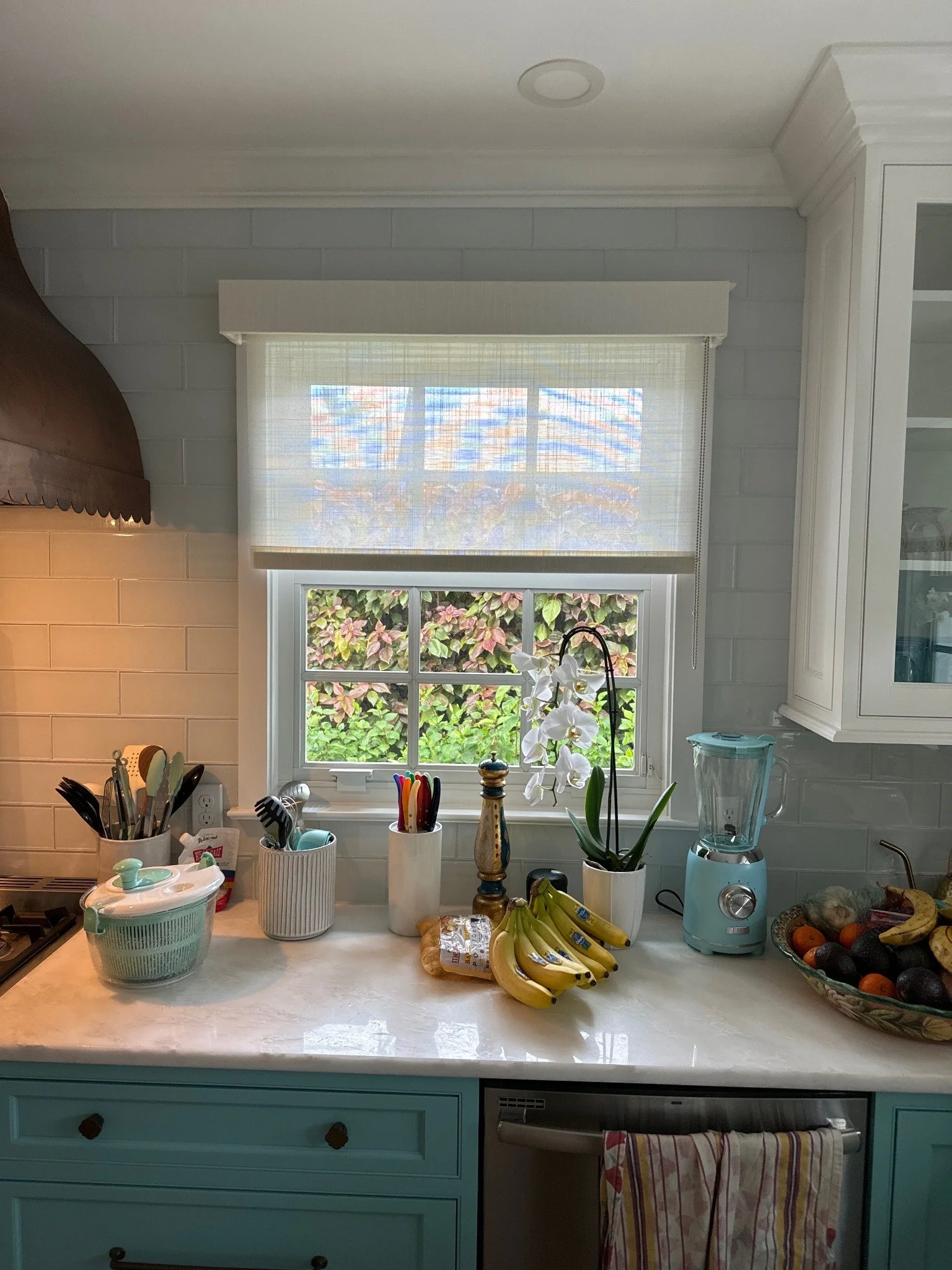 A neutral shade above a kitchen counter.