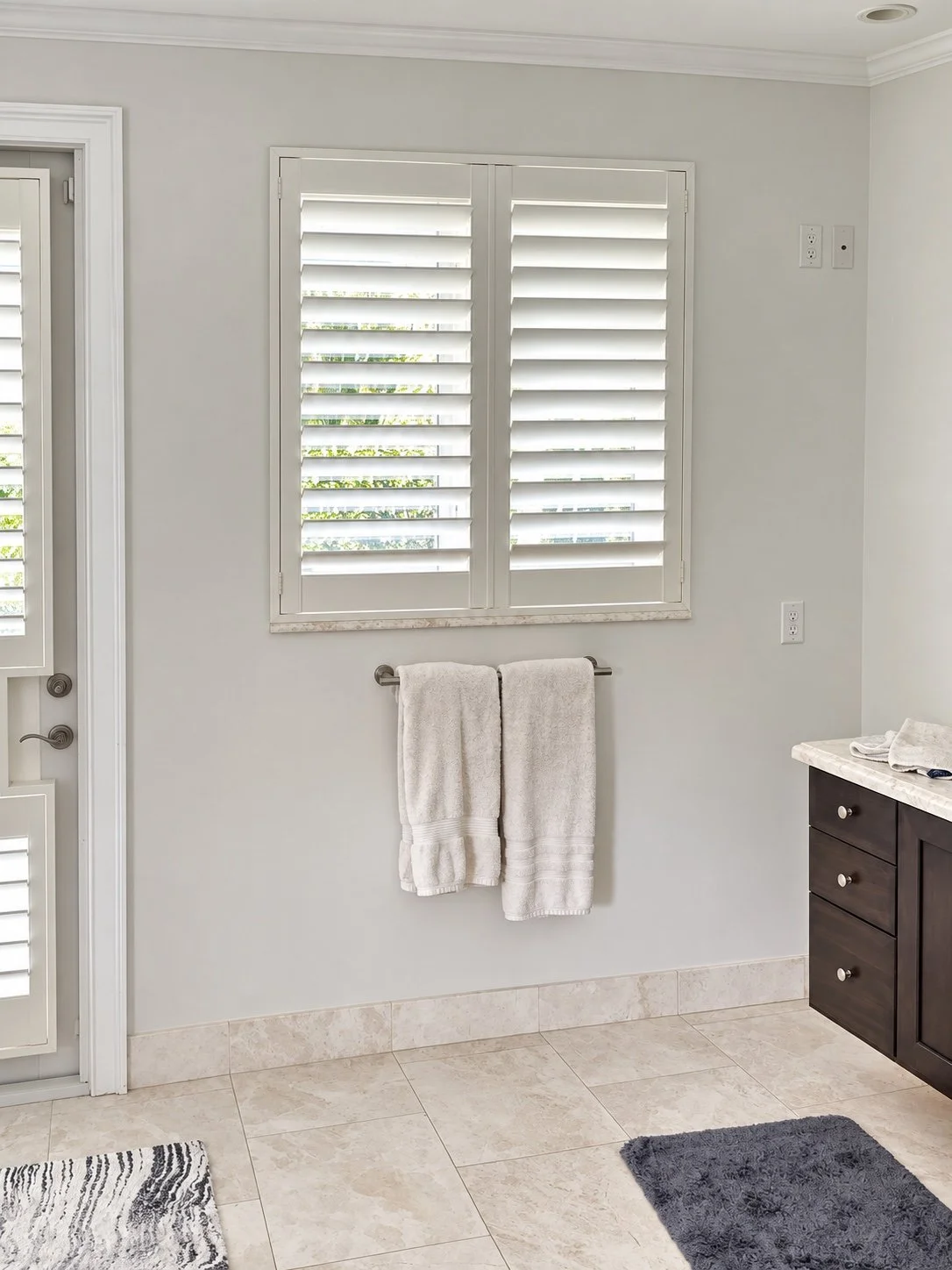Bathroom plantation shutters providing privacy and adjustable light.