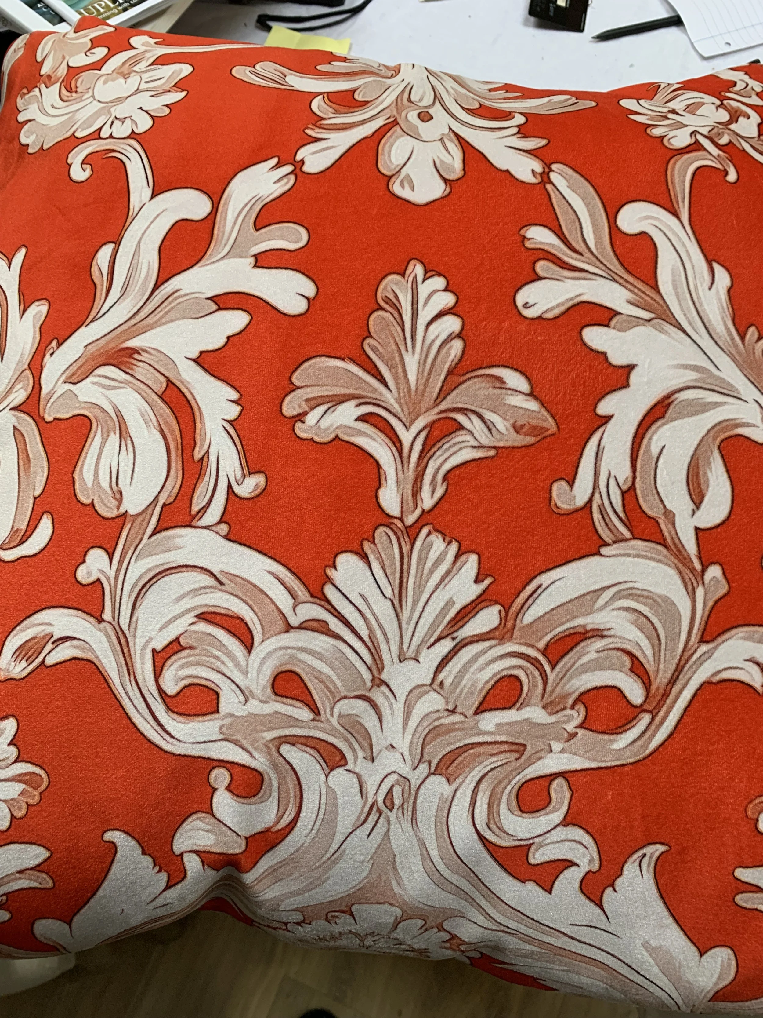 Ornate floral pattern on orange fabric