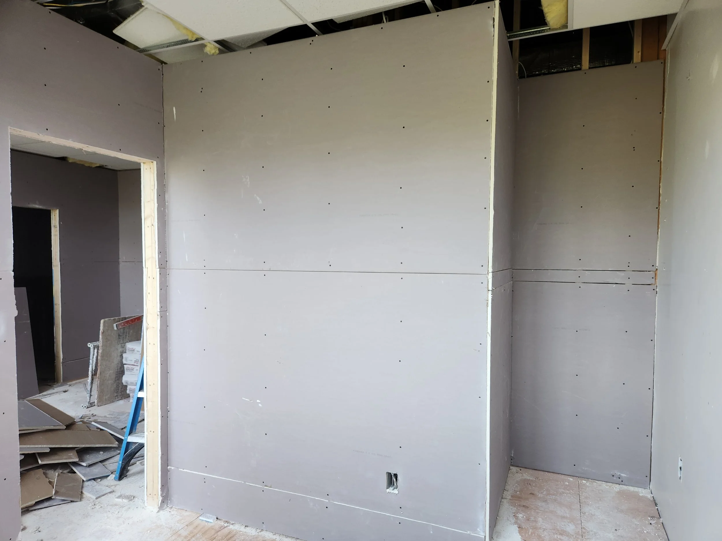Blue board and plaster were used in place of standard drywall to provide a smoother finish and a more durable wall system.