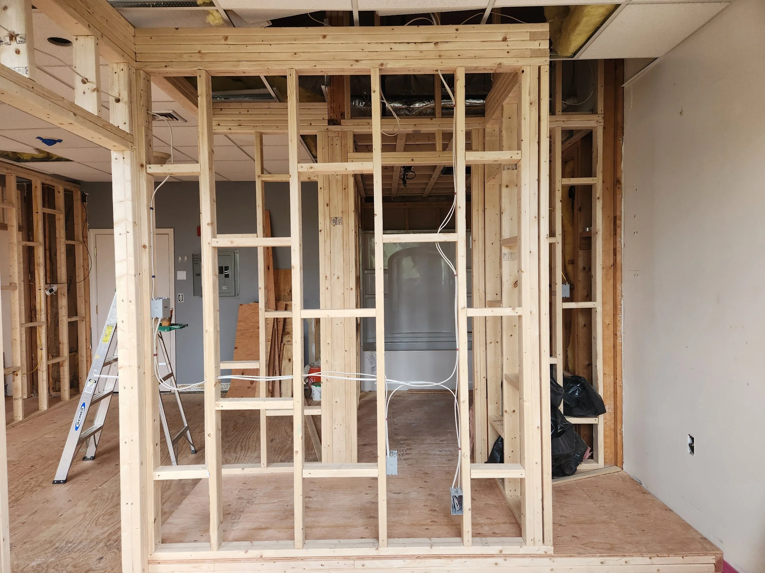 Additional headers were installed to eliminate the ceiling-to-wall gap present in other units, resulting in a stronger connection and improved overall wall integrity.