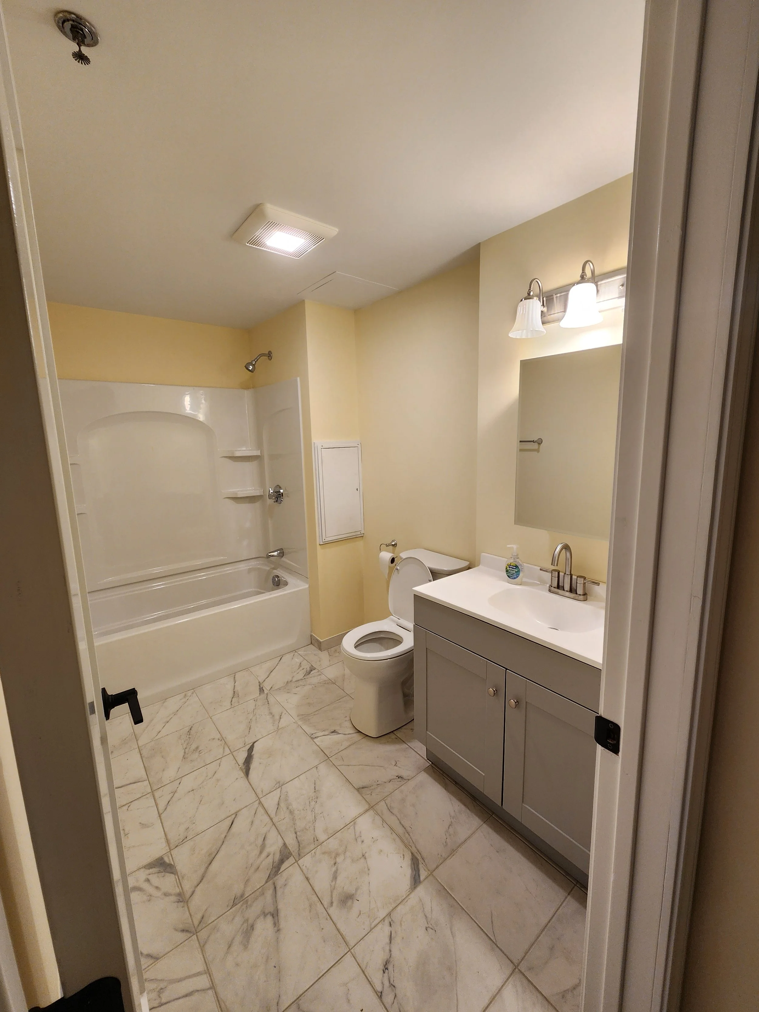 Completed bathroom following full structural rebuild, plumbing, and finish installations.