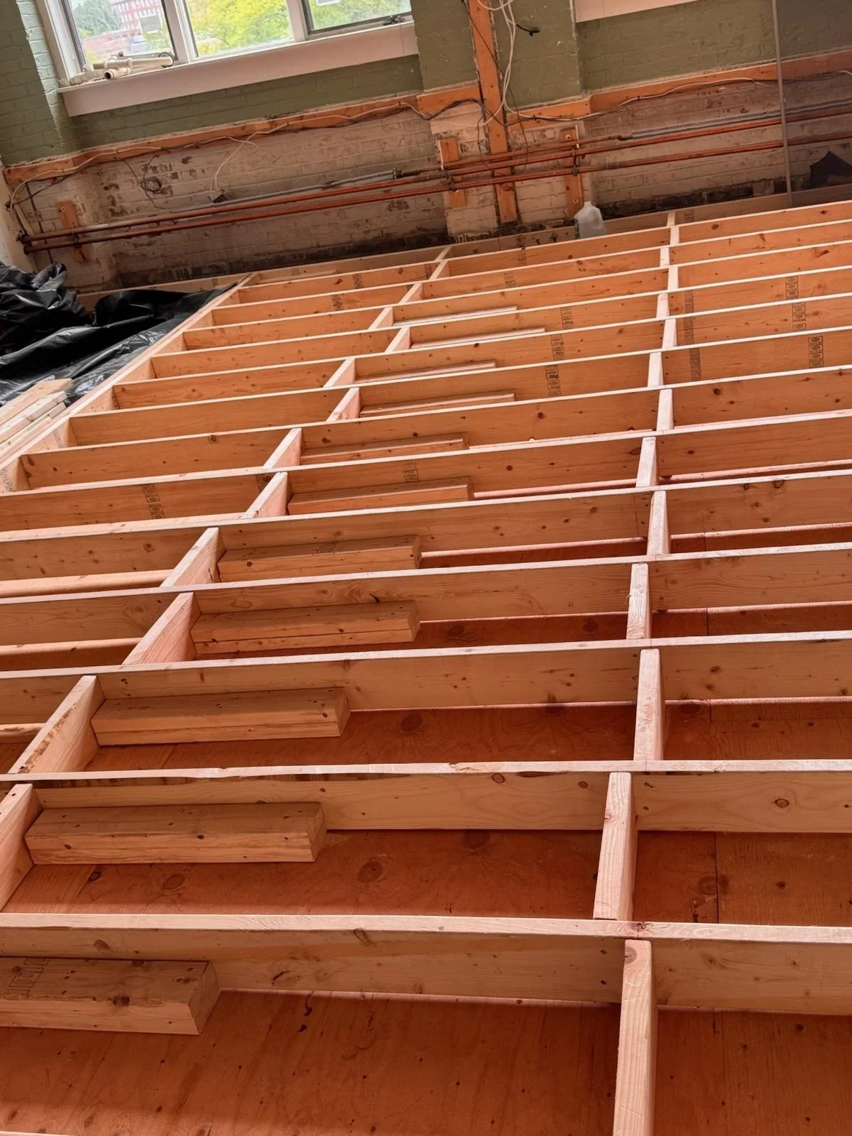 A new floor system was structurally framed and reinforced with additional blocking to ensure long-term stability.
