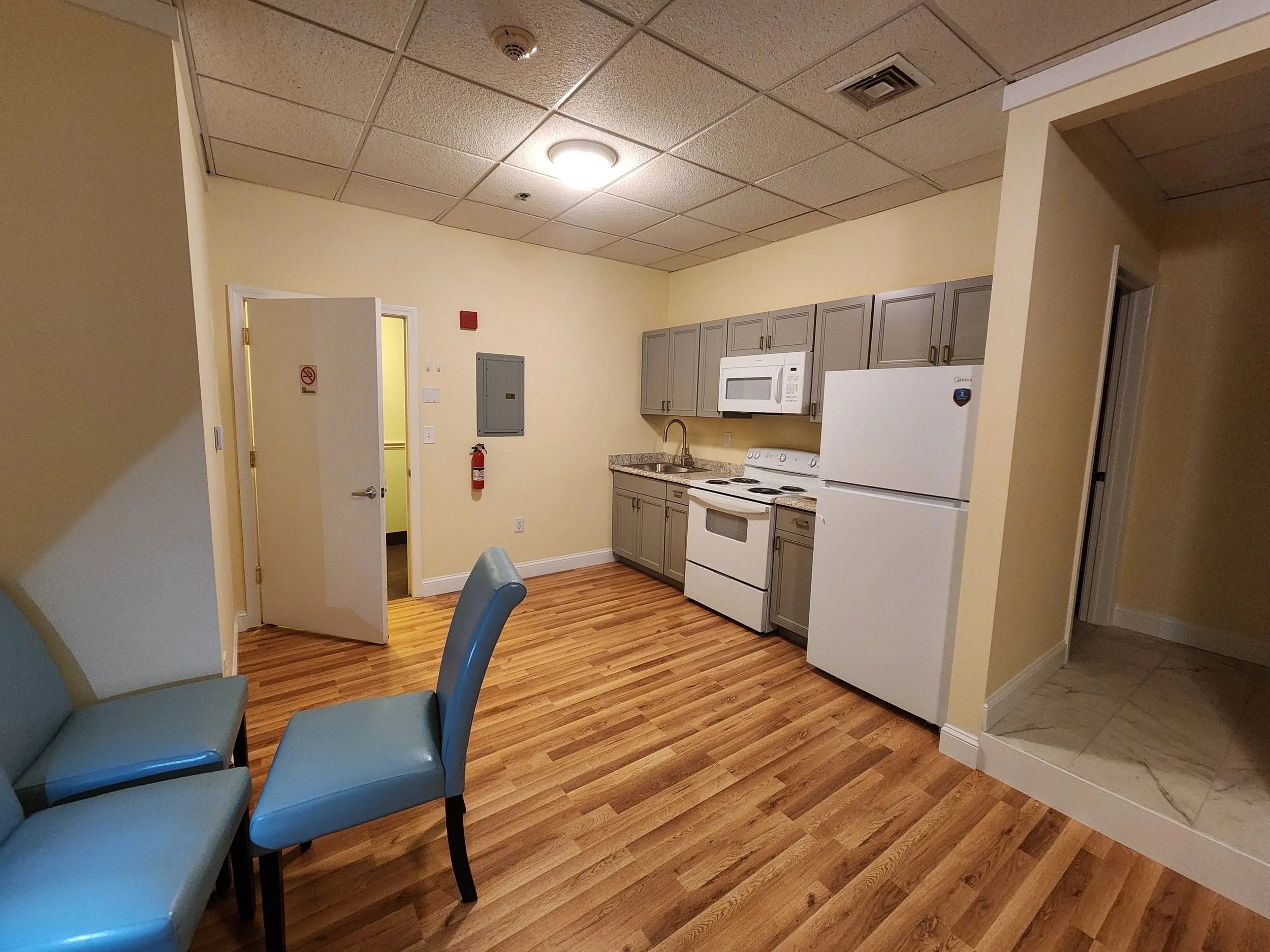 Finished living, dining, and kitchen area after complete interior reconstruction and finishing work.