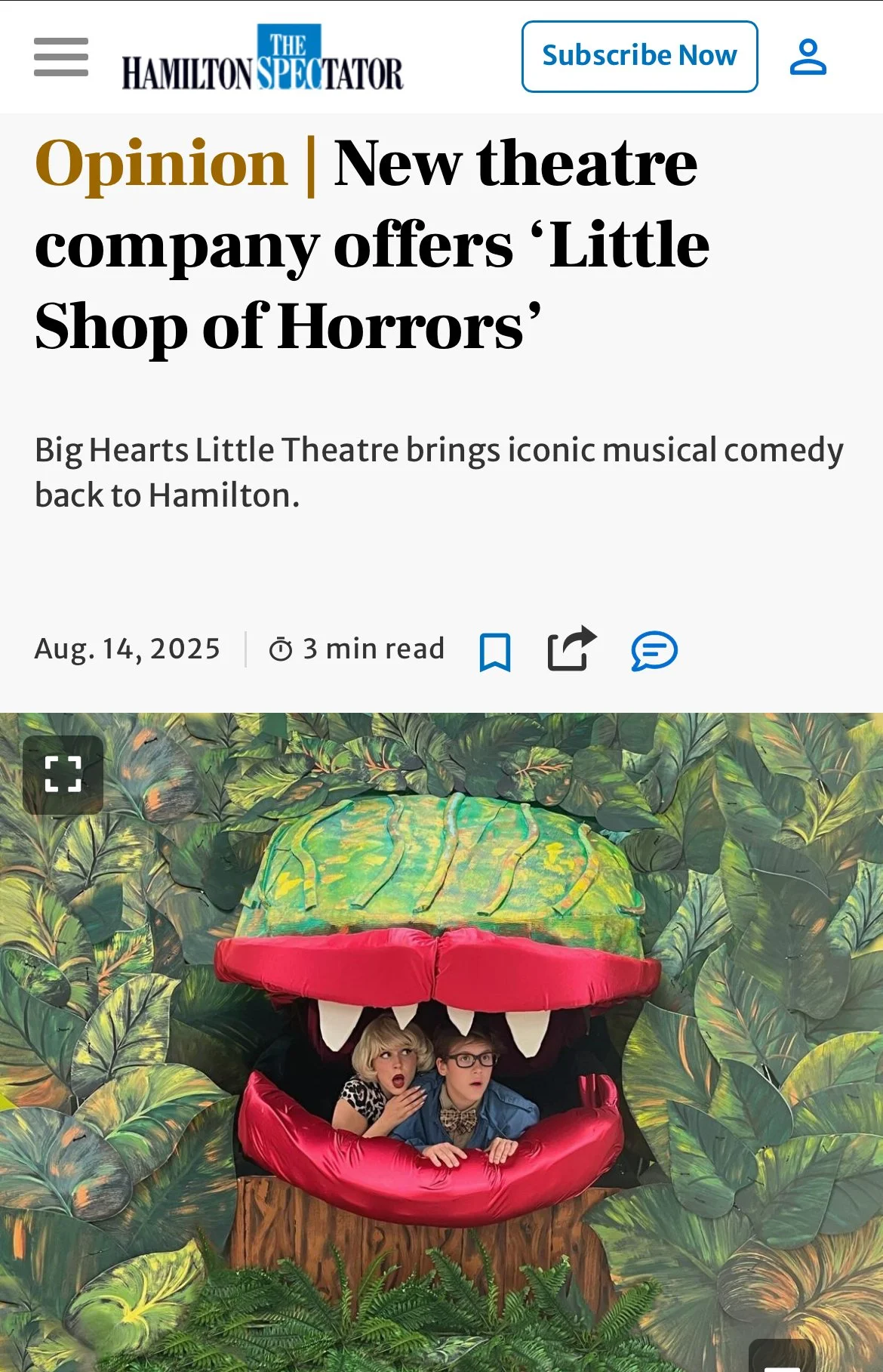 Two people with surprised expressions sitting inside an oversized, colorful, animated-looking dinosaur head photo booth with a jungle background.