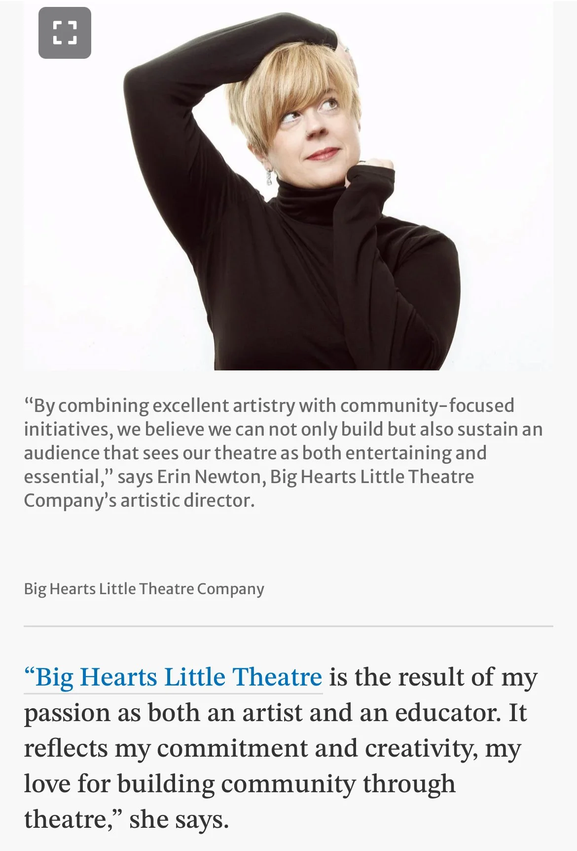 A woman with short blonde hair wearing a black turtleneck, posing with one arm raised over her head and the other bent at the elbow, against a plain white background.