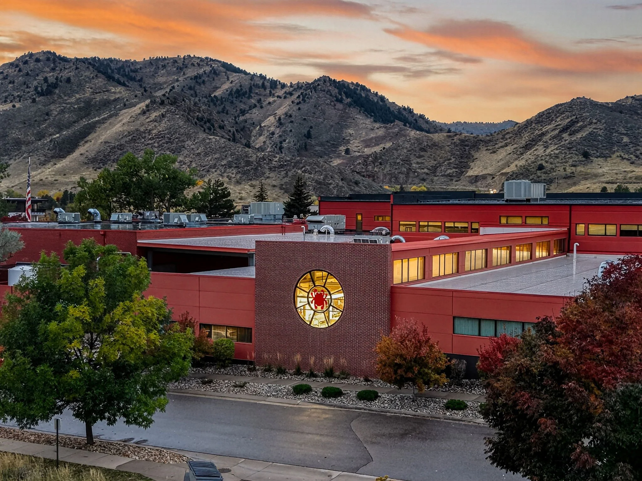 Spyderco's circular east window is celebrated in the early evening.  The building's expansion ensures that manufacturing can continue into the evening as demand increases.