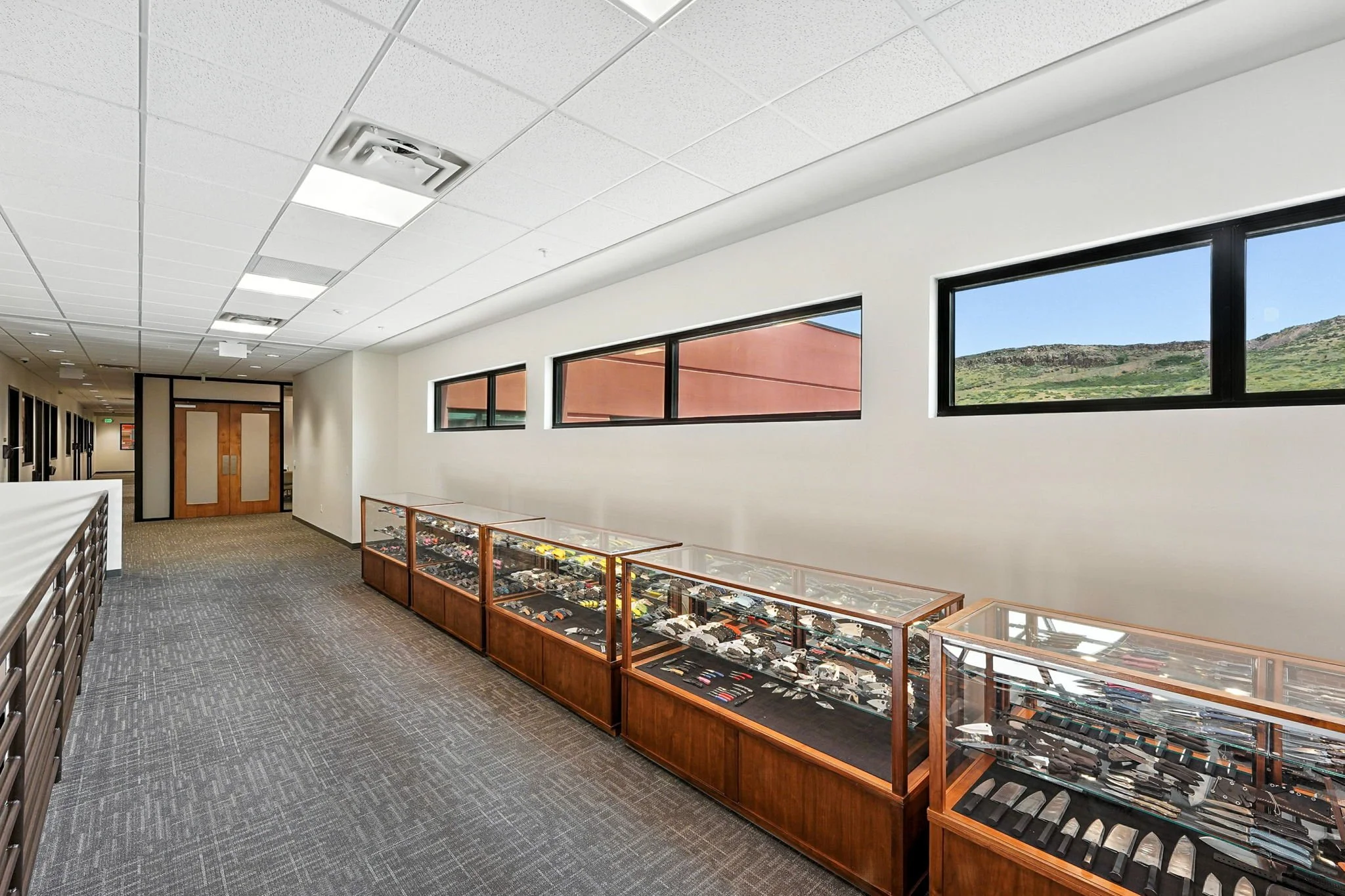 Spyderco: Gracious windows along the second floor bridge frame the views while bringing in natural light on the glass display cases that tell the history of Spyderco's vast array of knives.