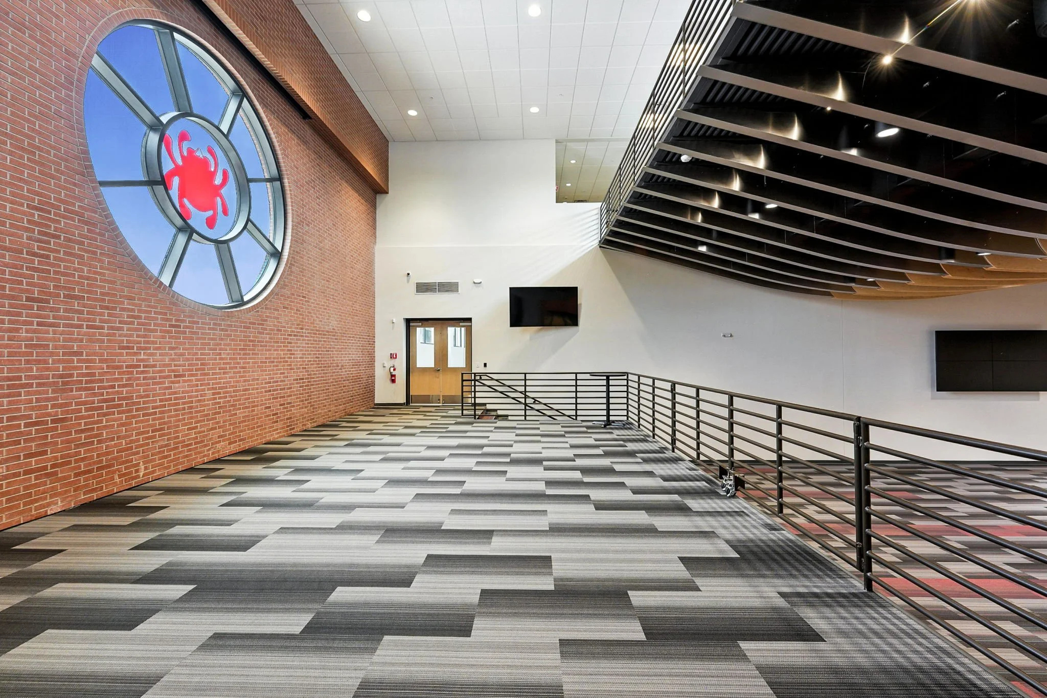 The circular Spyderco windows have become a celebrated design feature beloved by the staff and creates a powerful backdrop behind the stage.  Retractable shades drop from an integrated pocket and support with any presentation visuals.