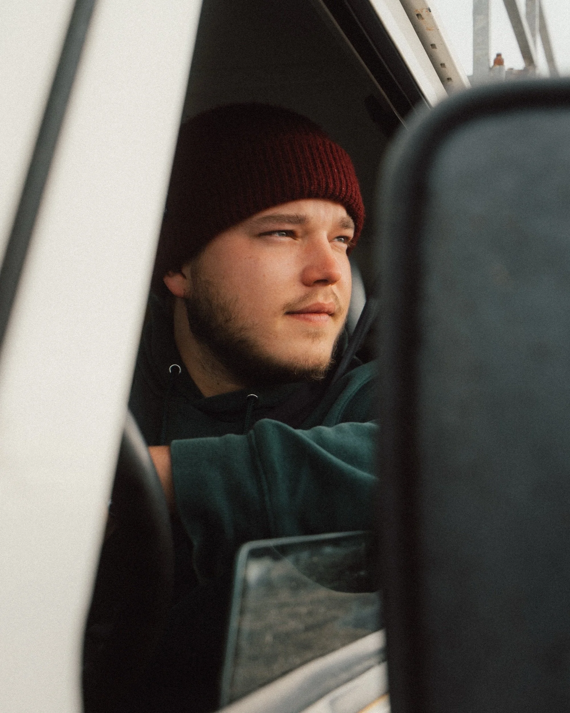 Portrait looking out of the Land Rover Defender window, road trip through Iceland