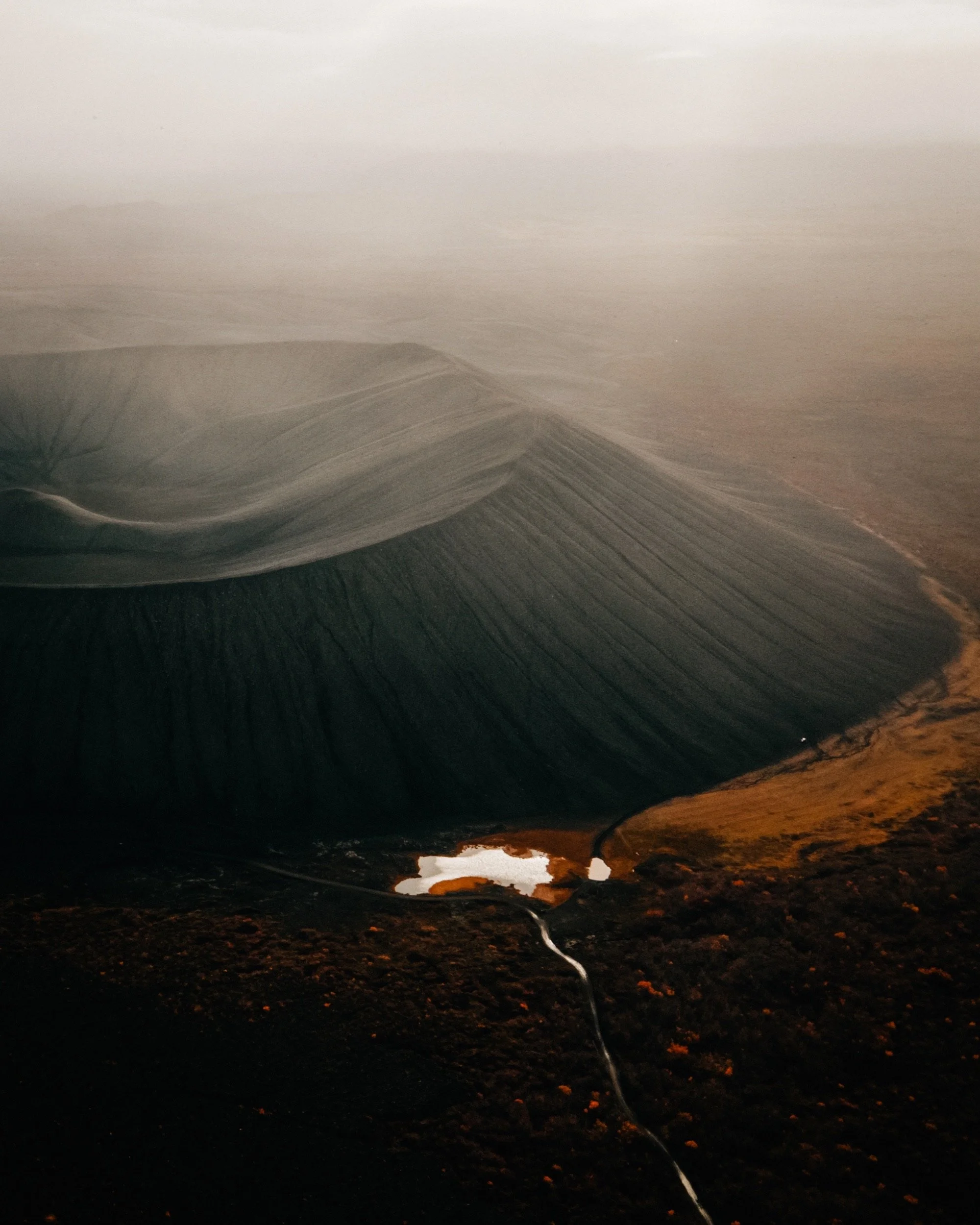 Aerial shot of a volcanic crater at sunset in North Iceland