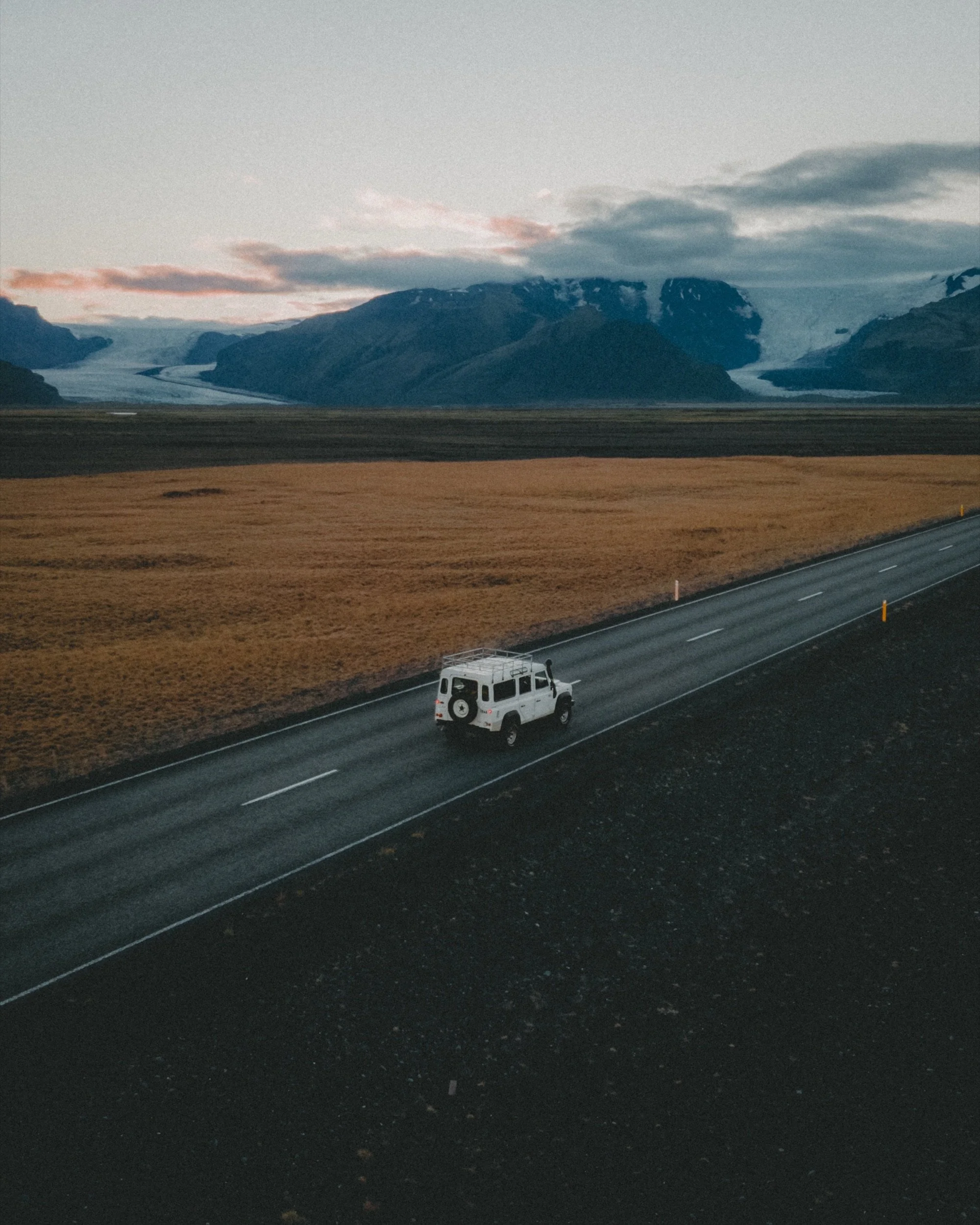 Aerial shot of a Land Rover Defender on the Ring Road at dusk, Iceland