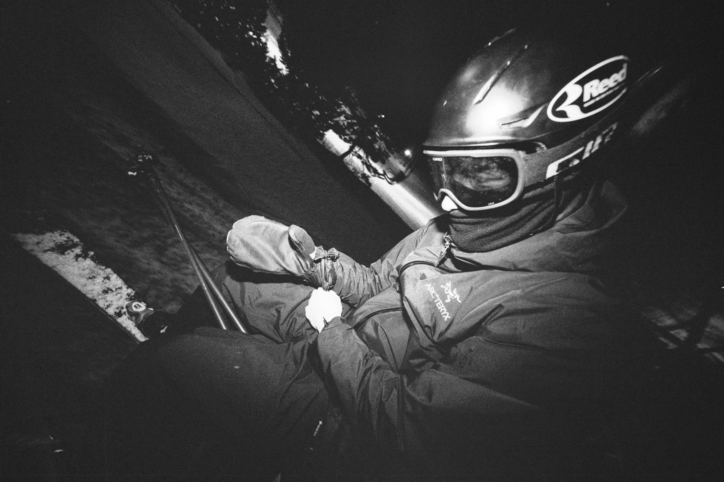 Fixing gear on the chairlift while night skiing in Madarao, Japan