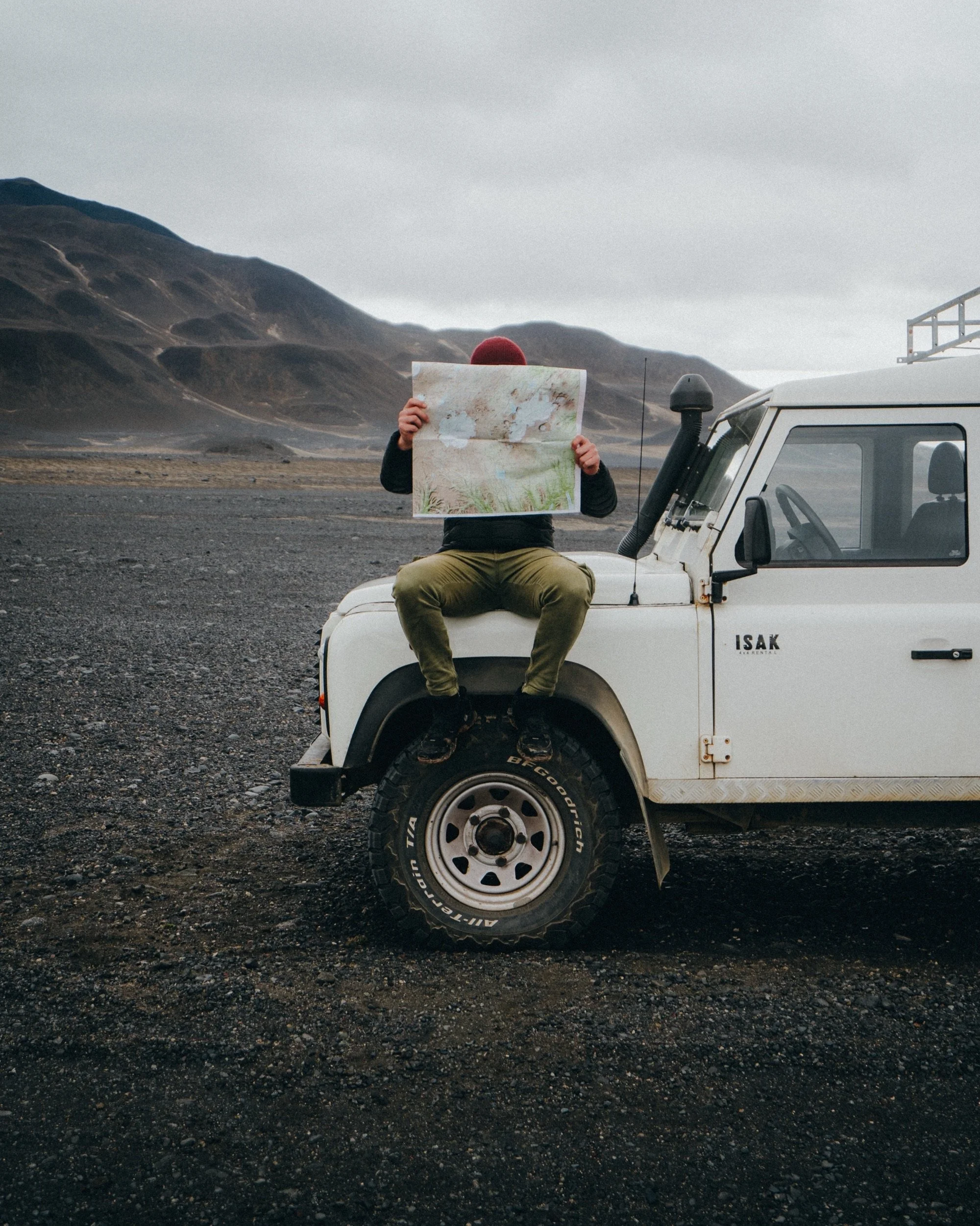 Reading the map on the hood of a Land Rover Defender, Icelandic Highlands.