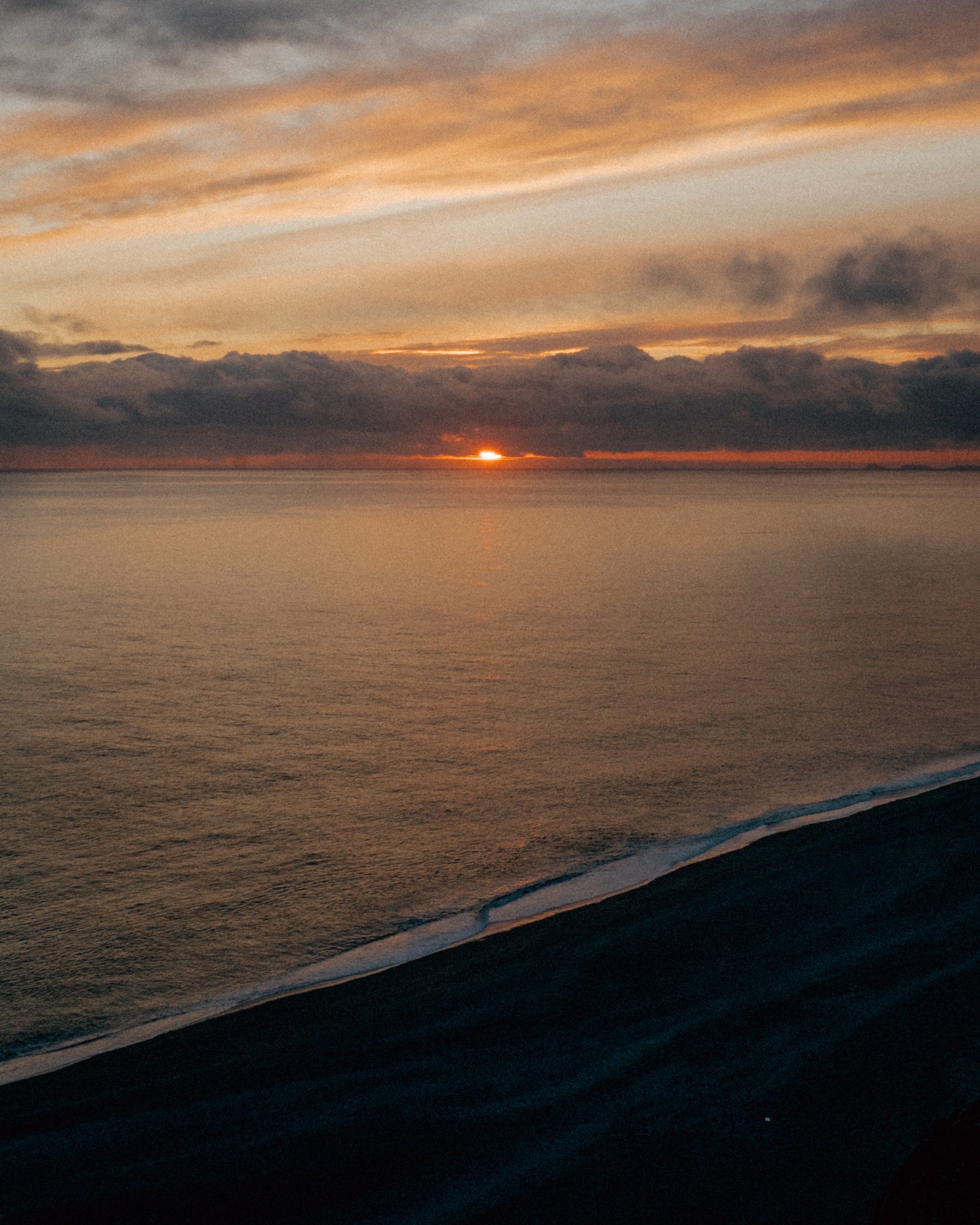 Sunset over the North Atlantic, waves on the Icelandic coast