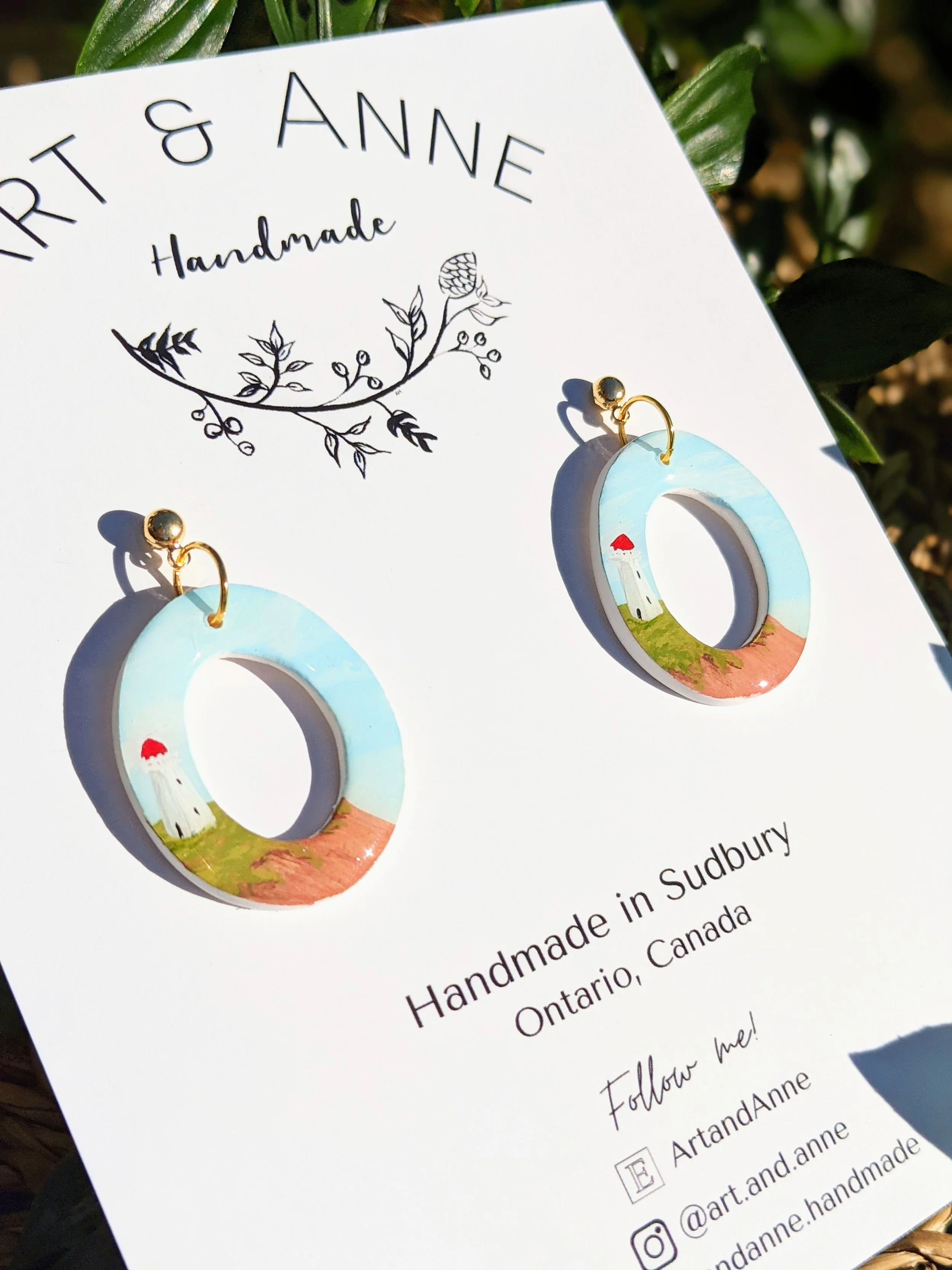 Custom hand-painted hoop earrings featuring lighthouses (2022)