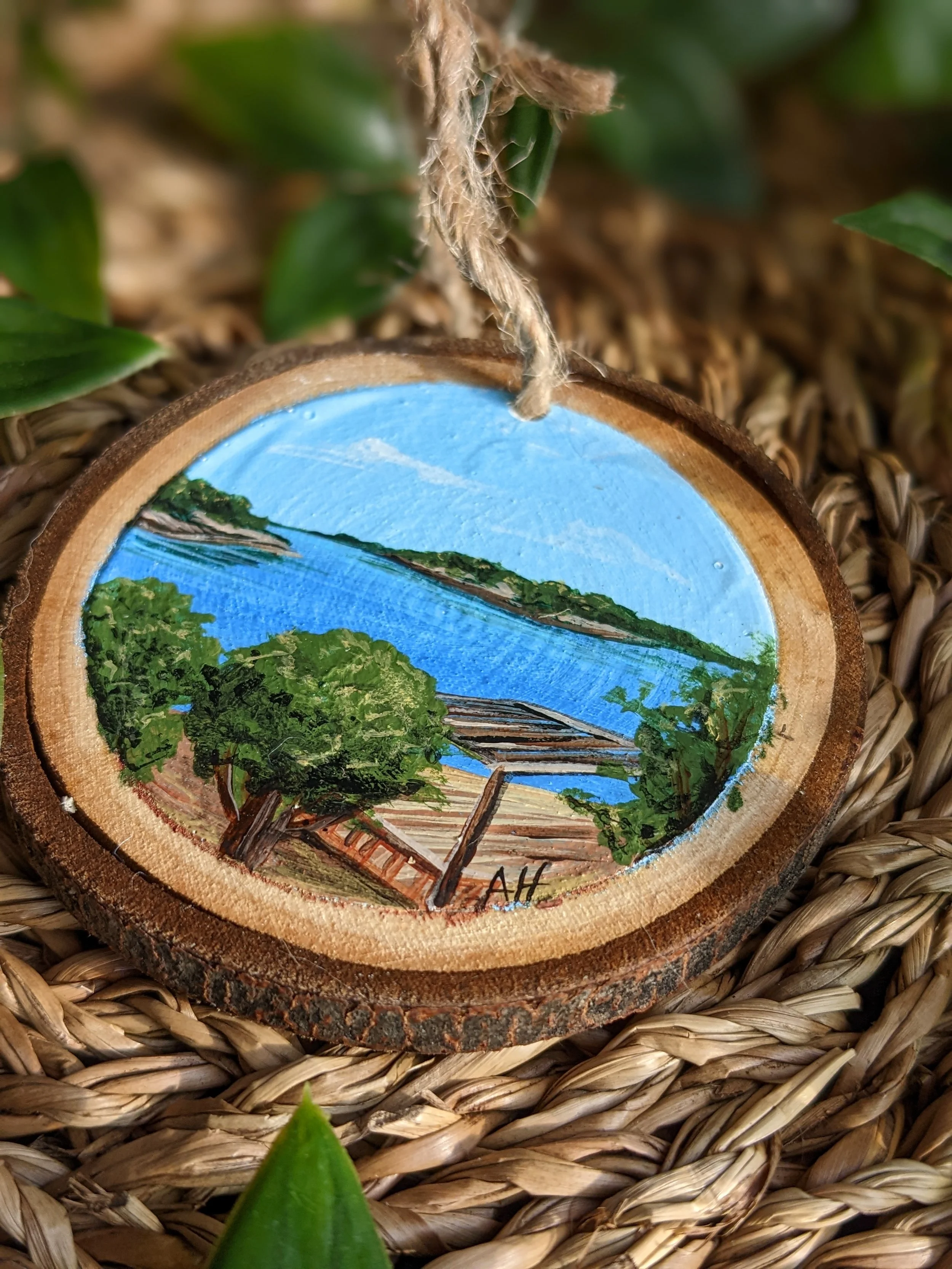 Custom hand-painted Christmas ornament featuring a lake view from a cottage (2022)