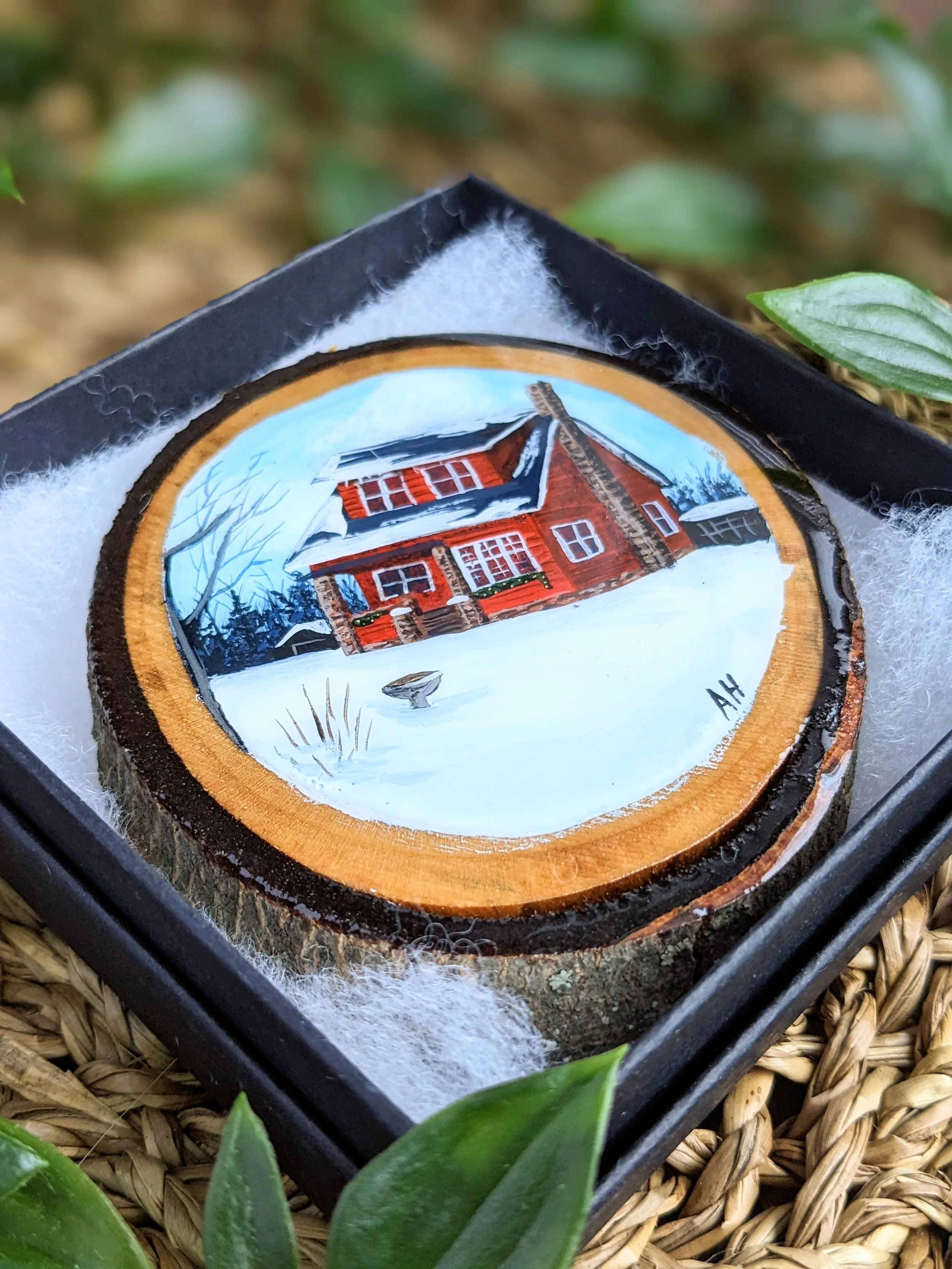 Custom hand-painted Christmas ornament featuring a red house in the winter (2023)