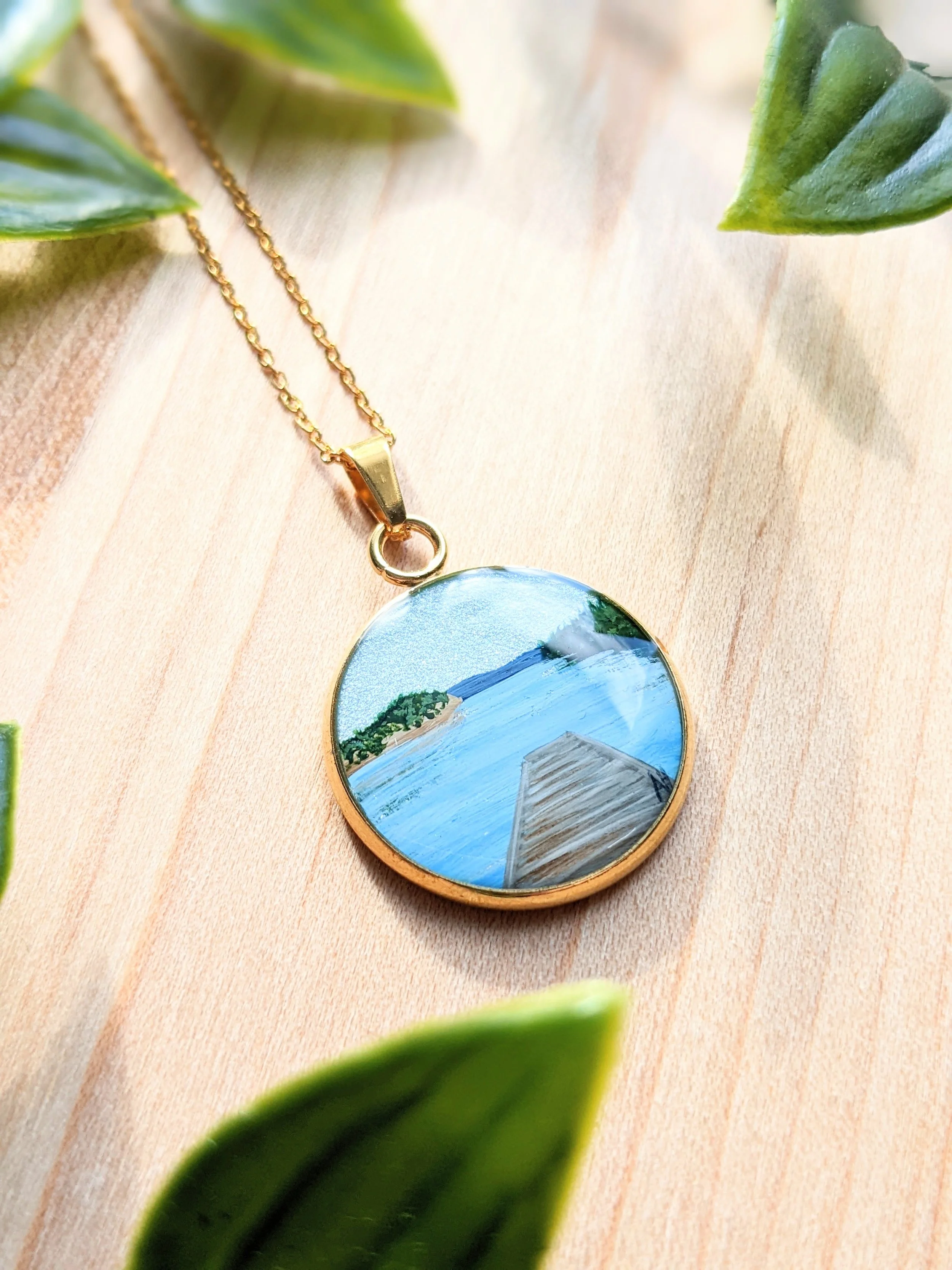 Custom hand-painted necklace featuring a dock (2022)