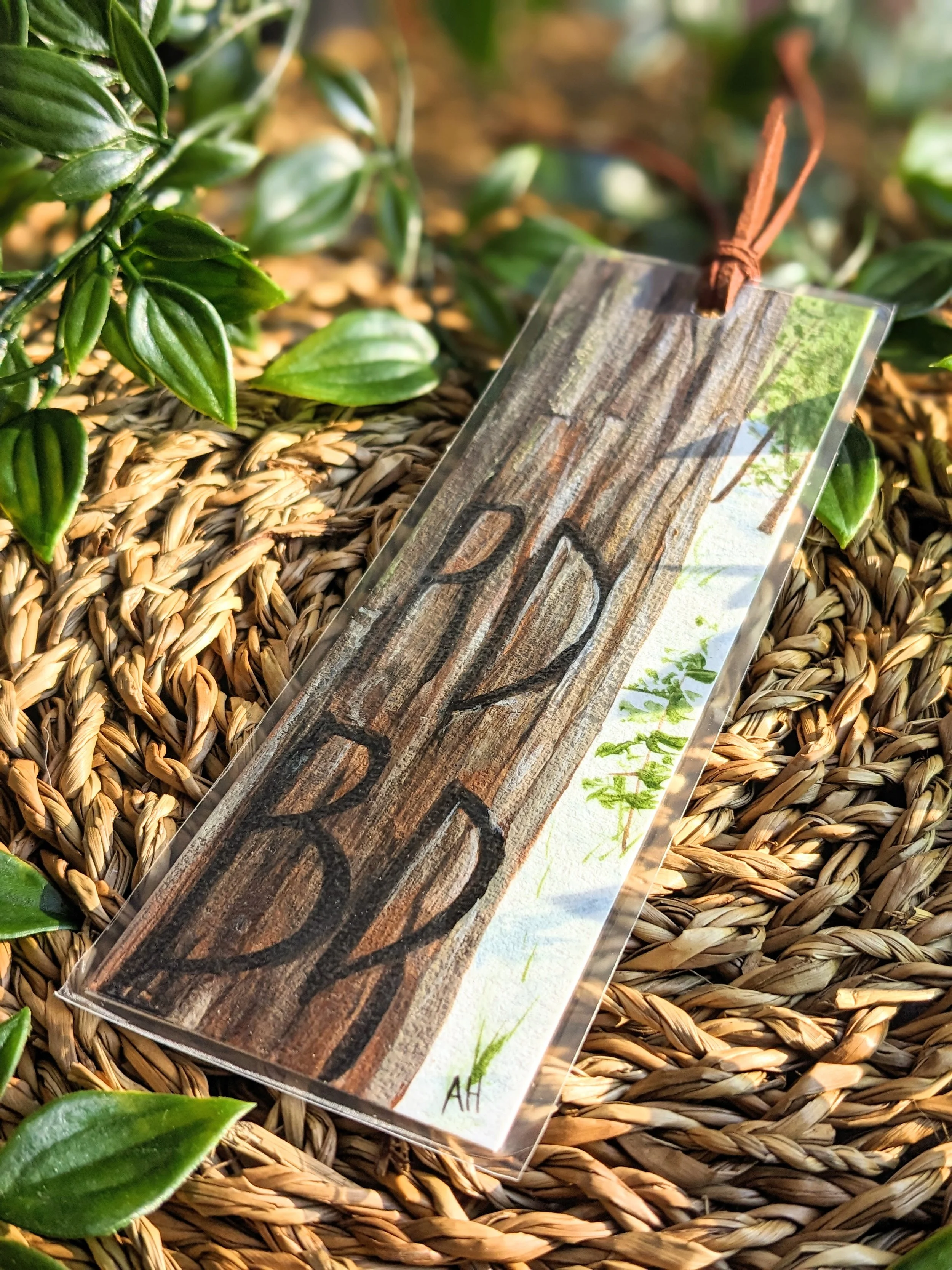 Custom hand-painted bookmark featuring initials carved into a tree (2022)