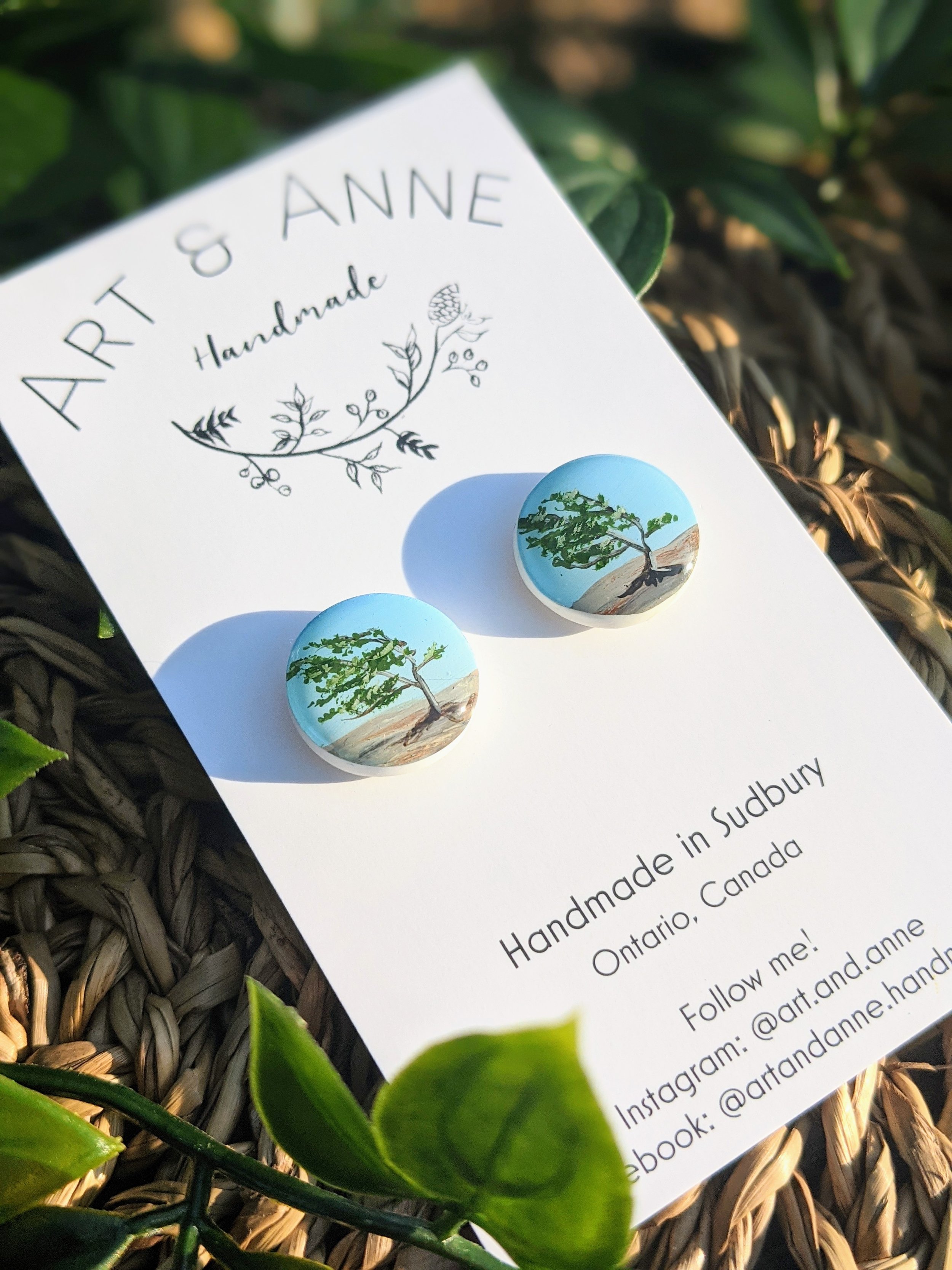 Custom hand-painted stud earrings featuring a windswept tree from Georgian Bay, Ontario (2022)