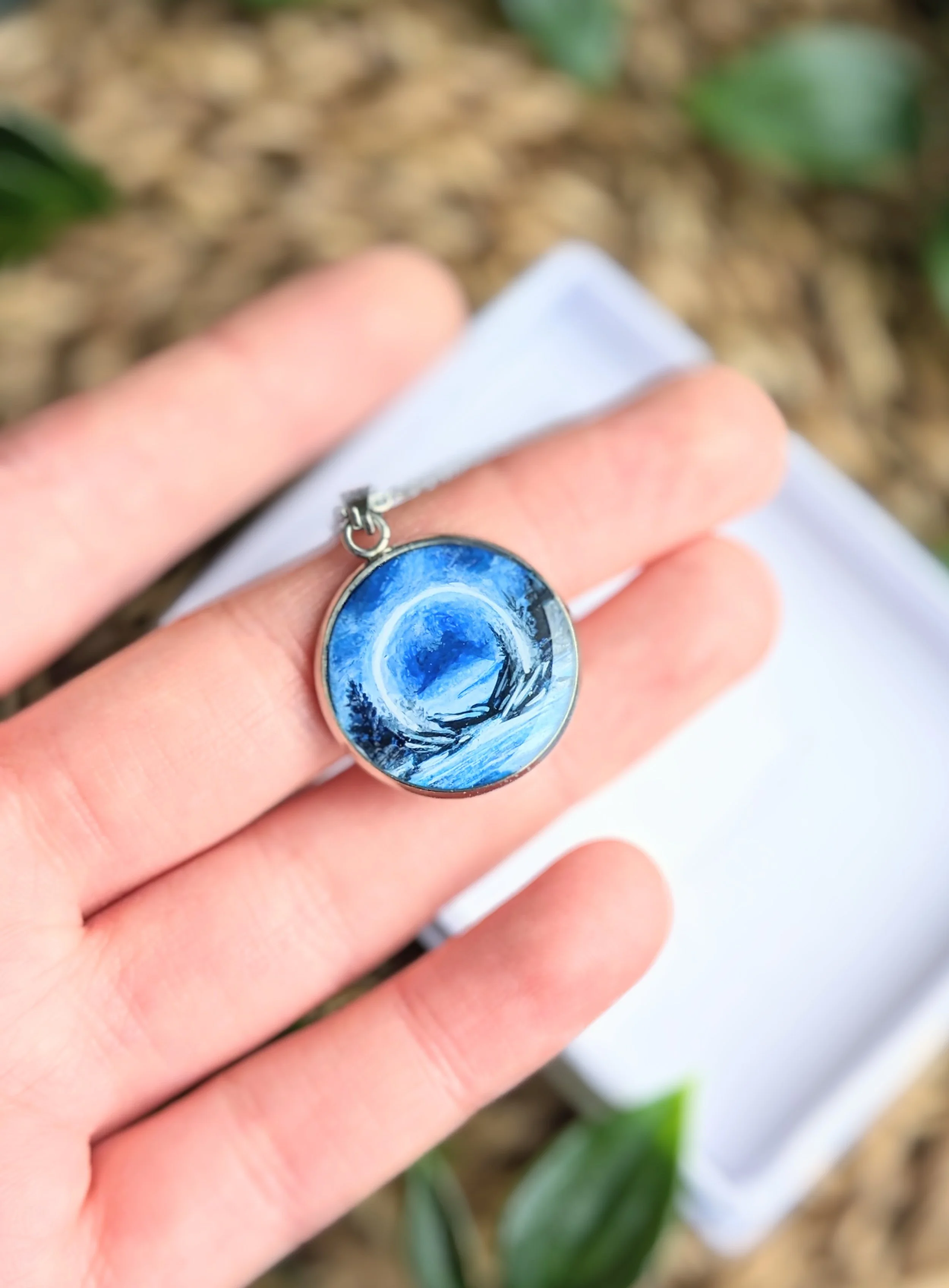 Custom hand-painted necklace featuring a scene from a book (2023)