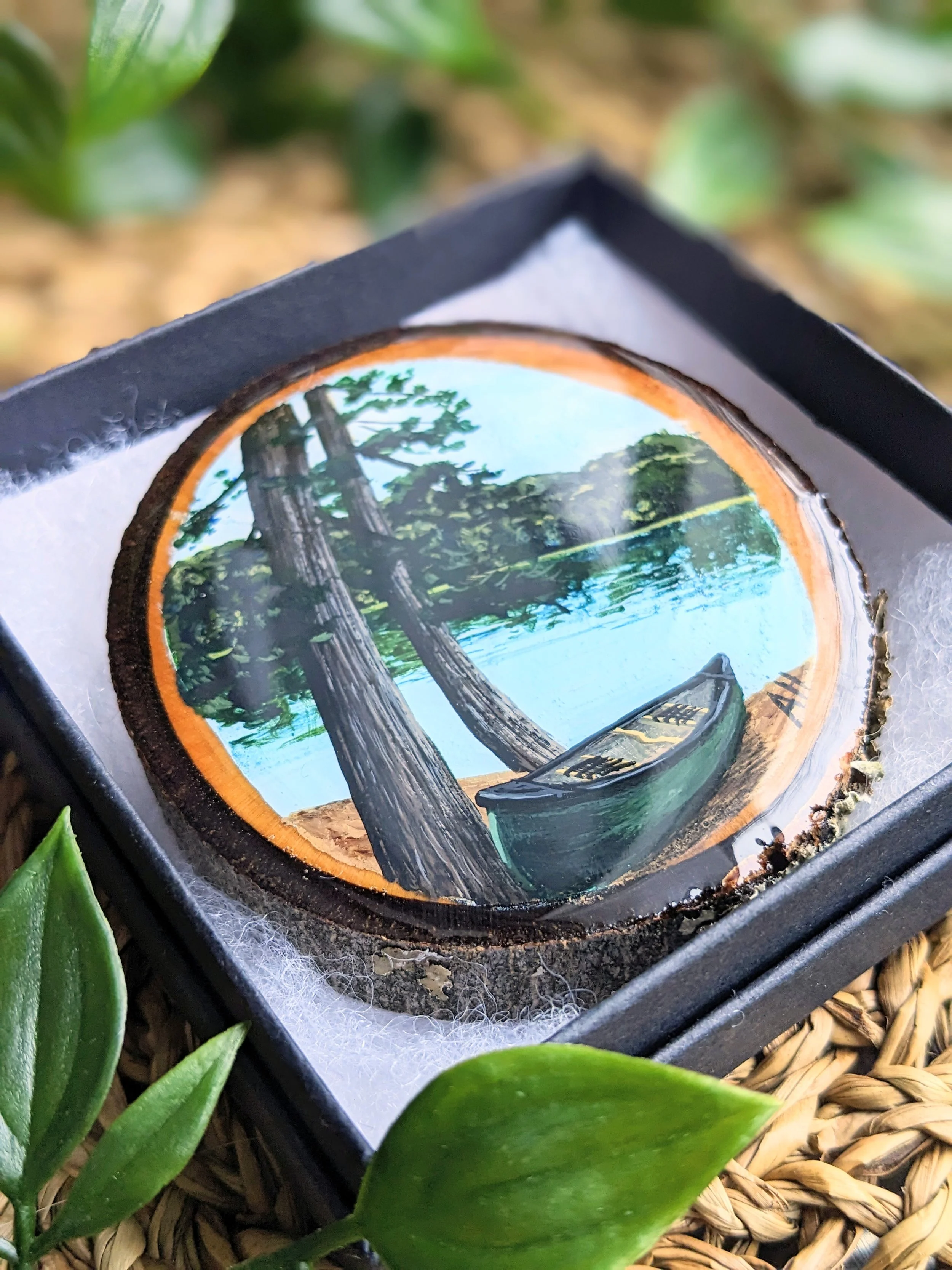 Custom hand-painted Christmas ornament featuring a green canoe (2023)