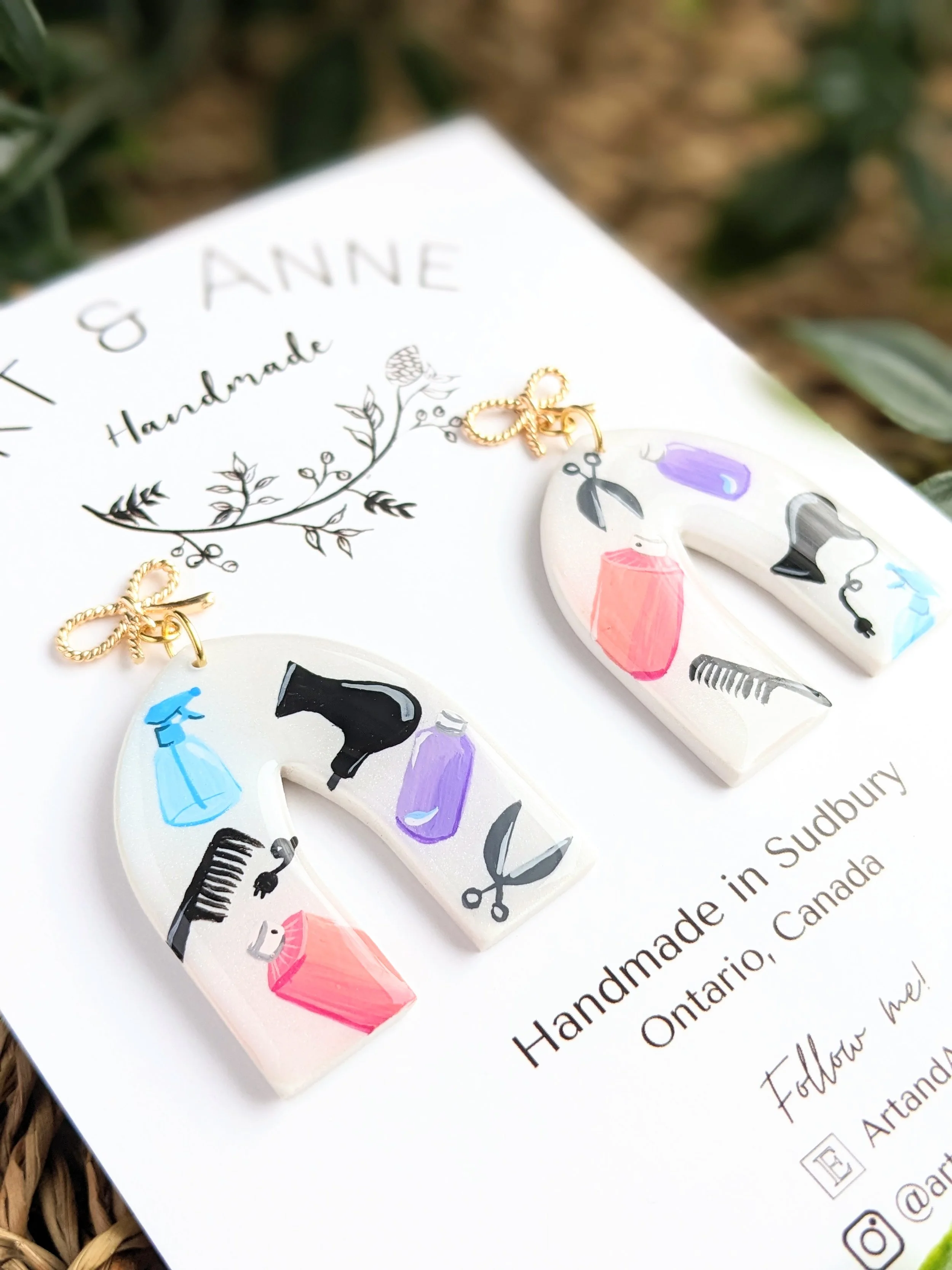Custom hand-painted statement earrings featuring hair stylist tools (2022)
