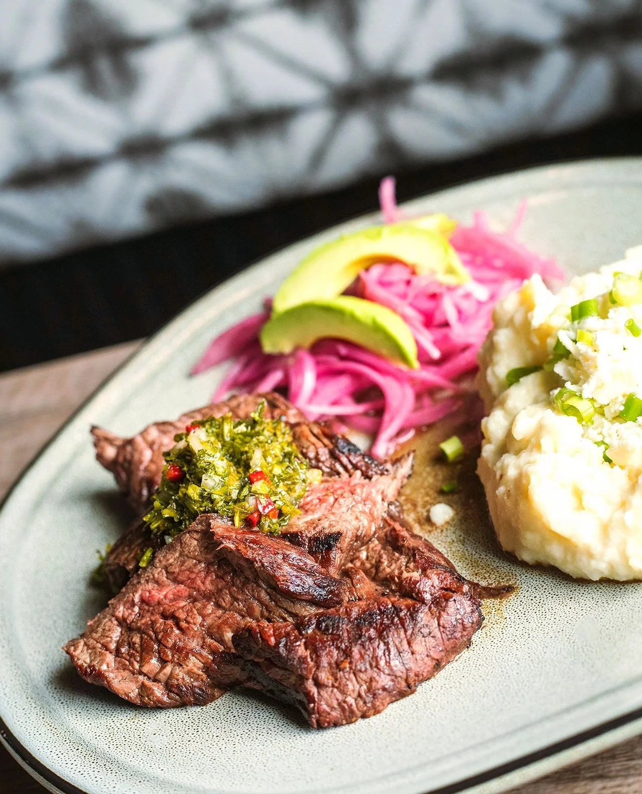 A meal fit for a king...or dad. Same thing I guess. 👑⁠
⁠
CARNE ASADA⁠
grilled sirloin bavette, chimichurri verde, mashed potato, sliced avocado, queso fresco, pickled red onion⁠
⁠
Reservations and walk-ins available!
