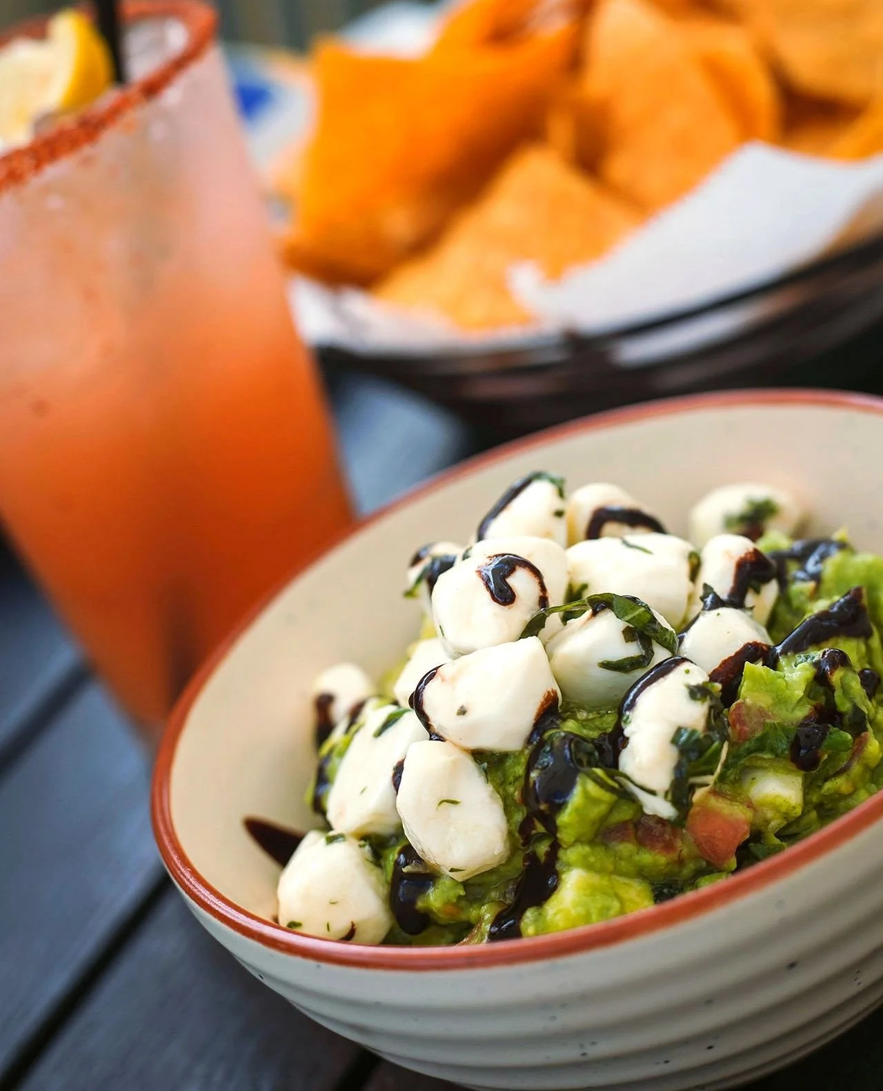 Had a pretty bad case of the Mondays this morning and then I remembered this Caprese Guac exists 😍⁠
⁠
Fresh mozzarella pearls, basil, balsamic drizzle &ndash; available this week at Mezcal!