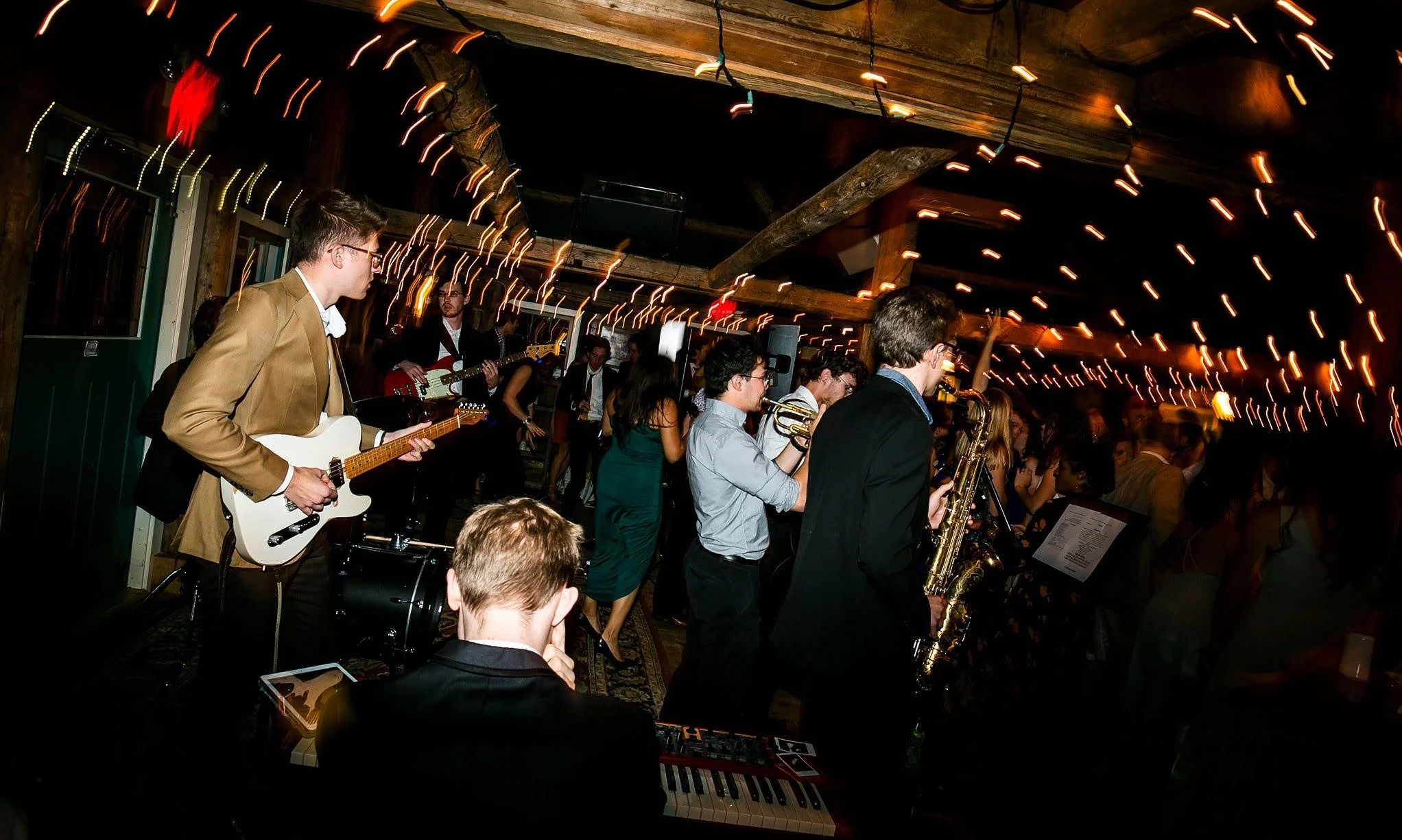 Party band with drums, guitar, trumpet, bass, vocals perform at VIP corporate function