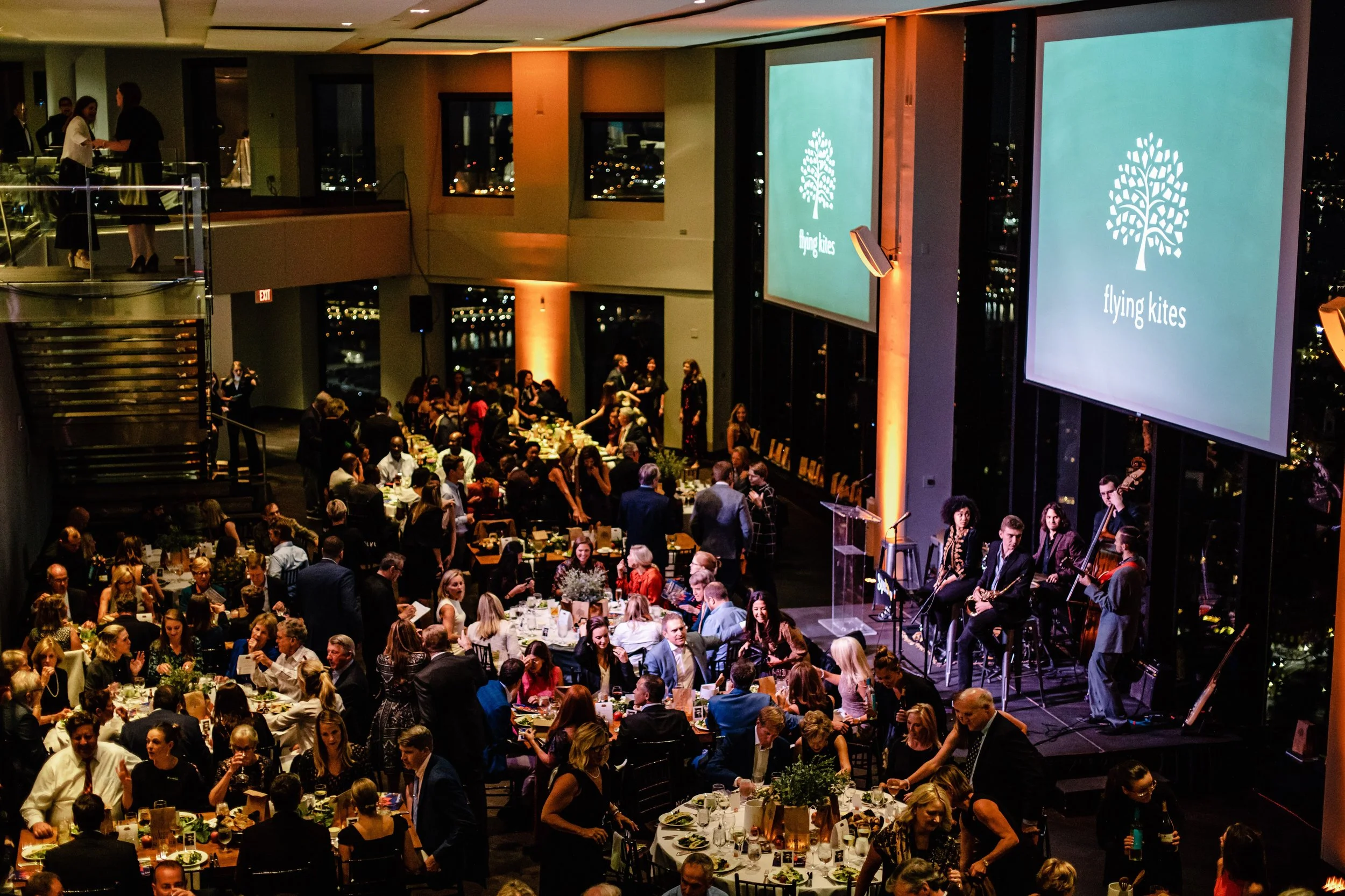 Party band with singer, saxophone, bass, drums, guitar, and keyboard perform at gala fundraiser