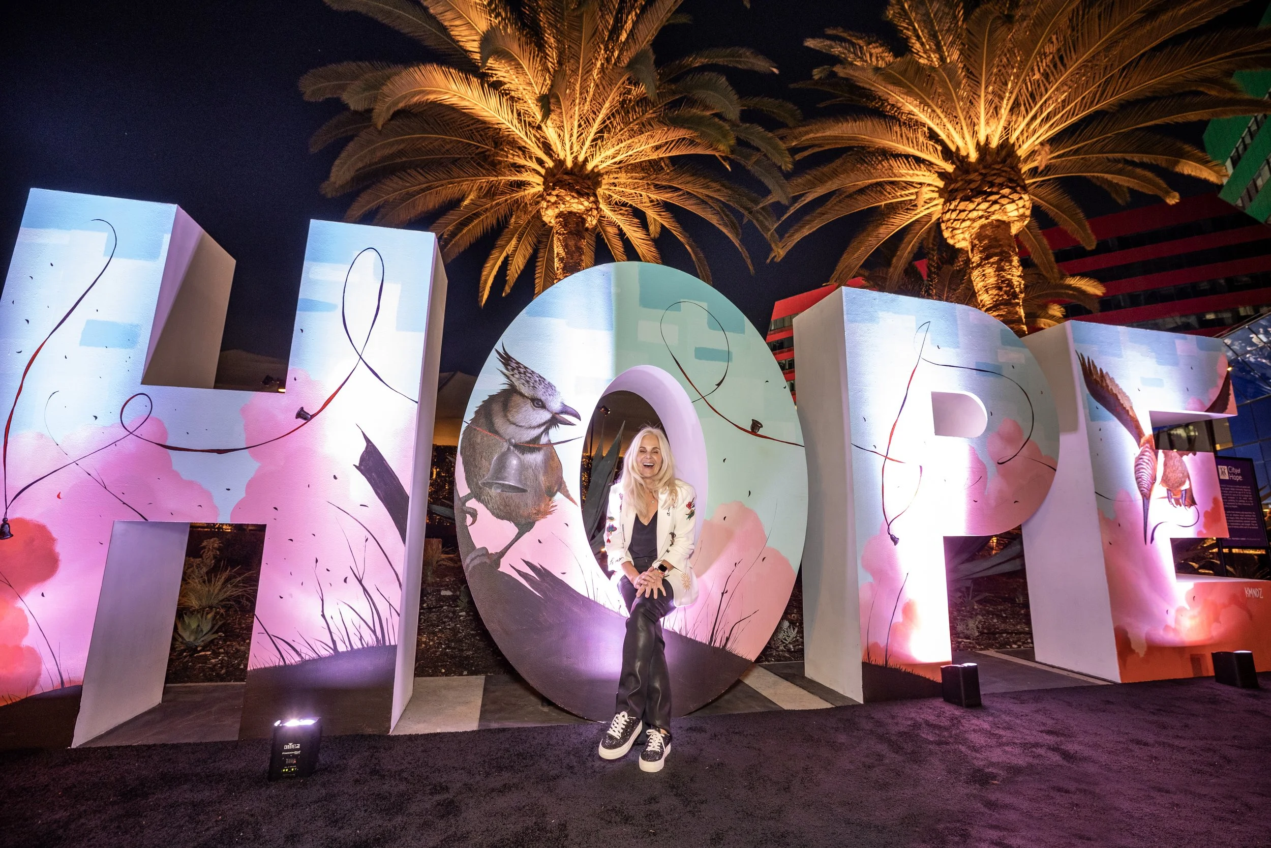 The purple carpet area and "HOPE" event branding with event planner, Natalie McAdams.