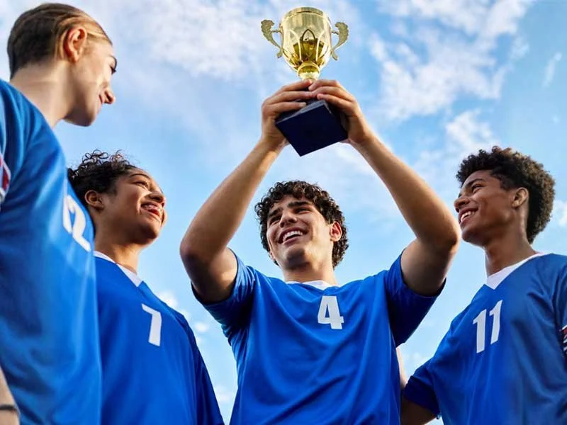 High school students holding up a trophy celebrating clear brain health with HBOT
