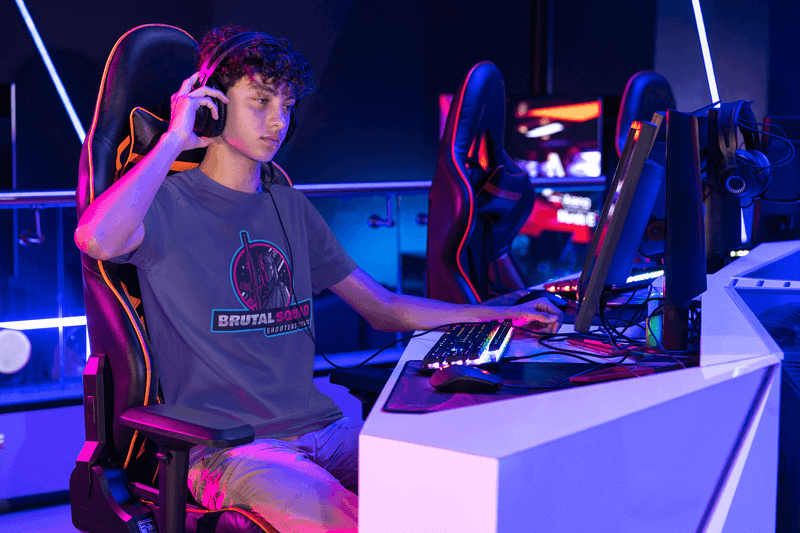 t-shirt mockup featuring a man at a gaming center