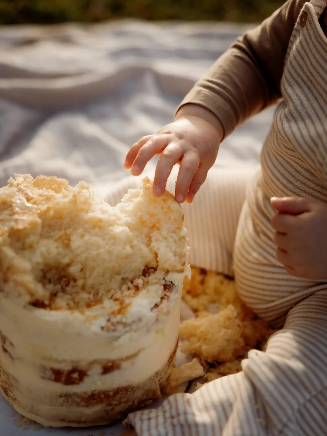 One whole year.
Twelve months ago he was hours old in a hospital bassinet while his big sisters pushed him down the hall for his first bath
Now he&rsquo;s being thrown in the air, smashing cake with his bare hands, and running this whole family like 