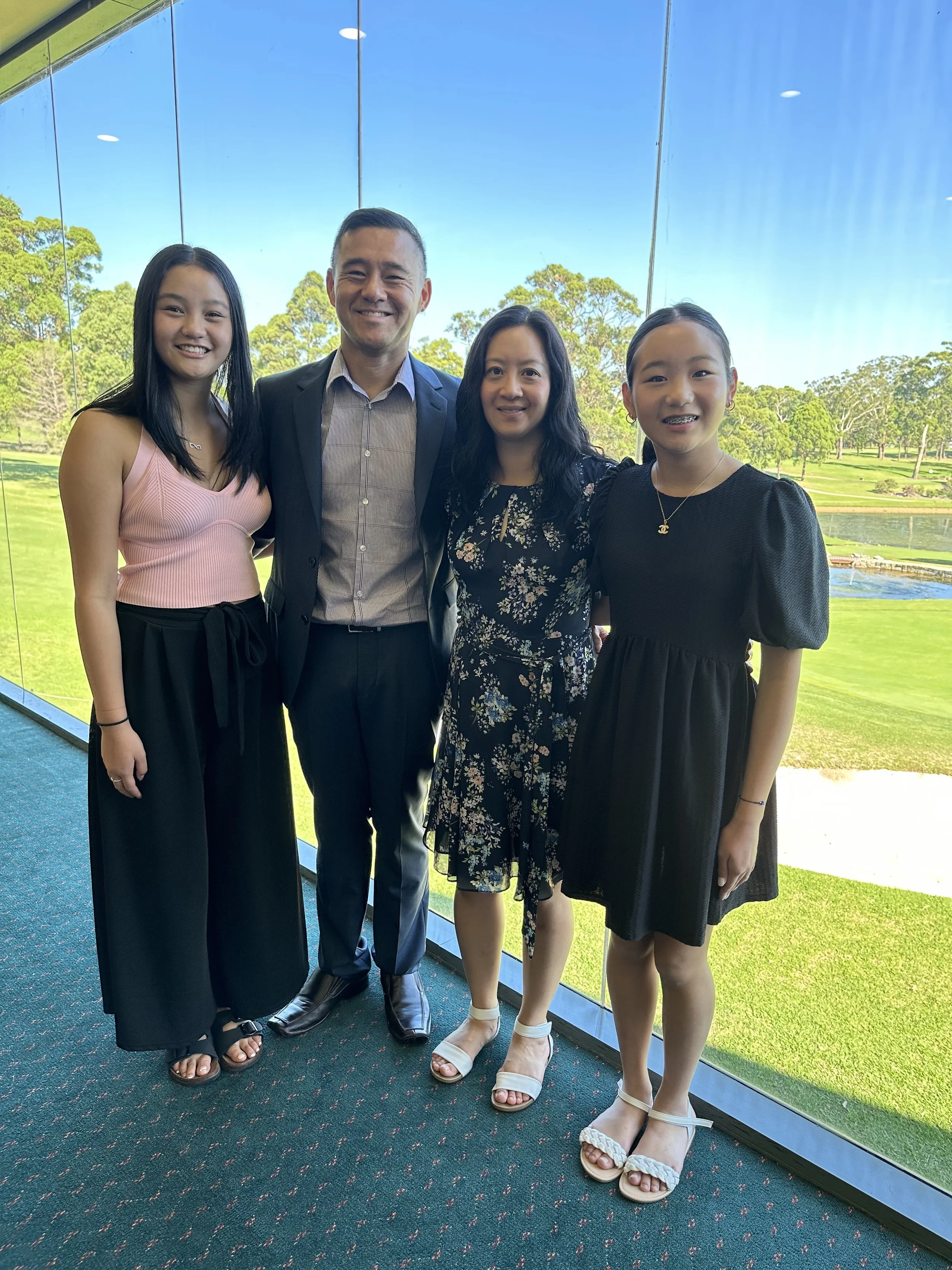 Laurie’s customers, Mariana and Carmen holding hands on a green lawn on their wedding day.