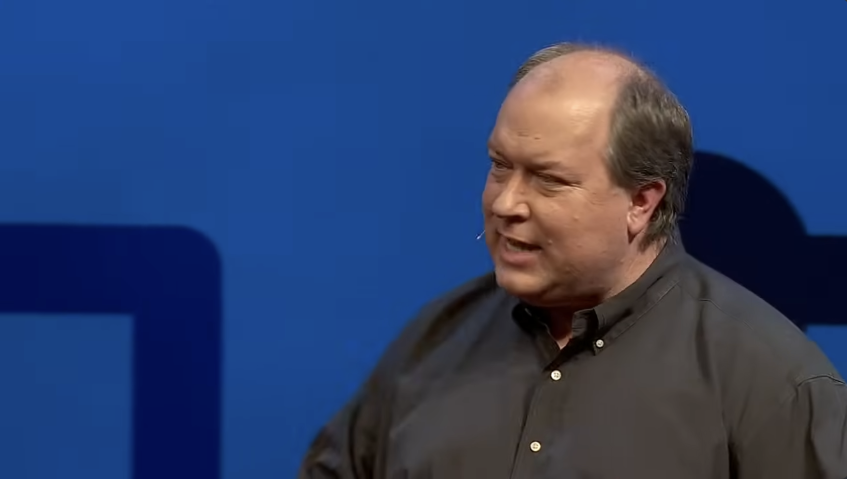 Dr. DooLittle speaking on a TEDTalk stage.