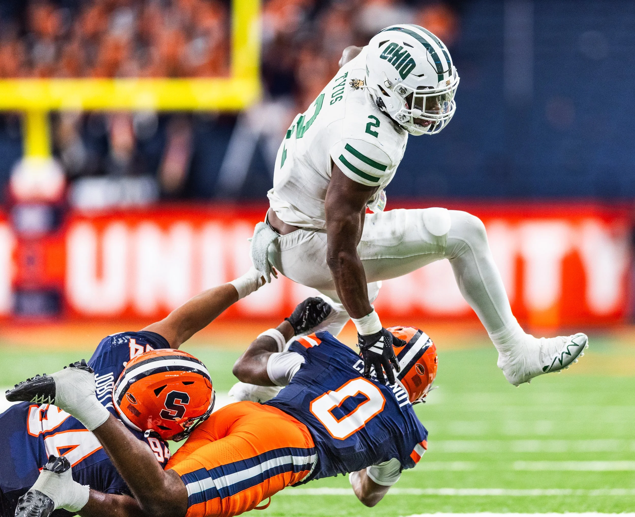 Ohio running back Anthony Tyus III (2) leaps over Syracuse defenders Duce Chestnut (0) and Kevin Jobity Jr. (94) during the season opener on Aug. 31, 2024, at the JMA Wireless Dome in Syracuse, N.Y.