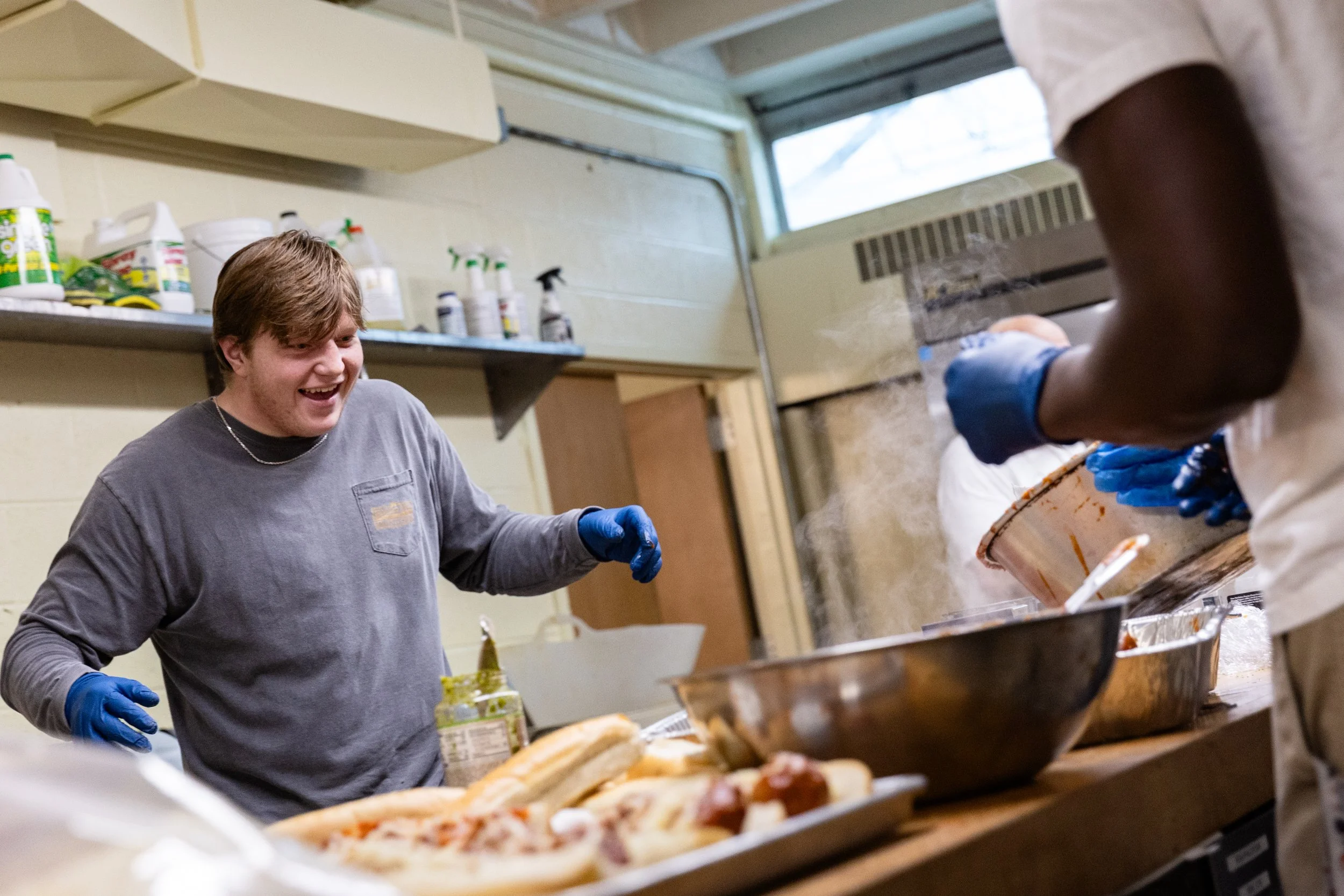 As part of their effort to establish their team as part of the local community, they actively participate in ways that don’t center around rugby, such as serving food to parishioners at All Saints Church. For Patrick, this isn’t just community servic