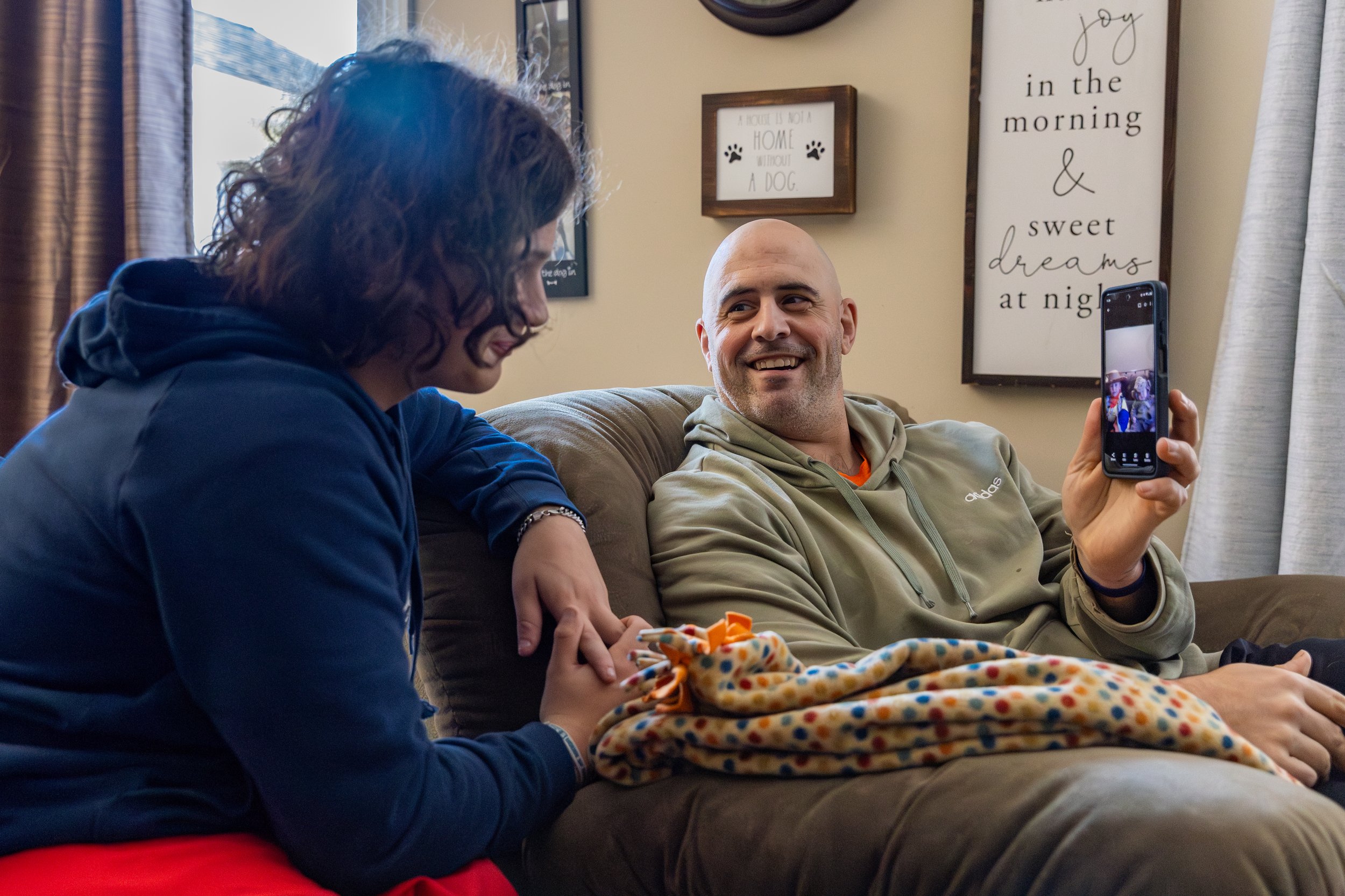 Jamie and Myles laugh while looking at a baby photo of Myles on Jamie’s phone.
When Jamie and his wife, Diane, learned that Myles would be born with a congenital disability, they made a choice about how they would raise him. They decided to raise hi