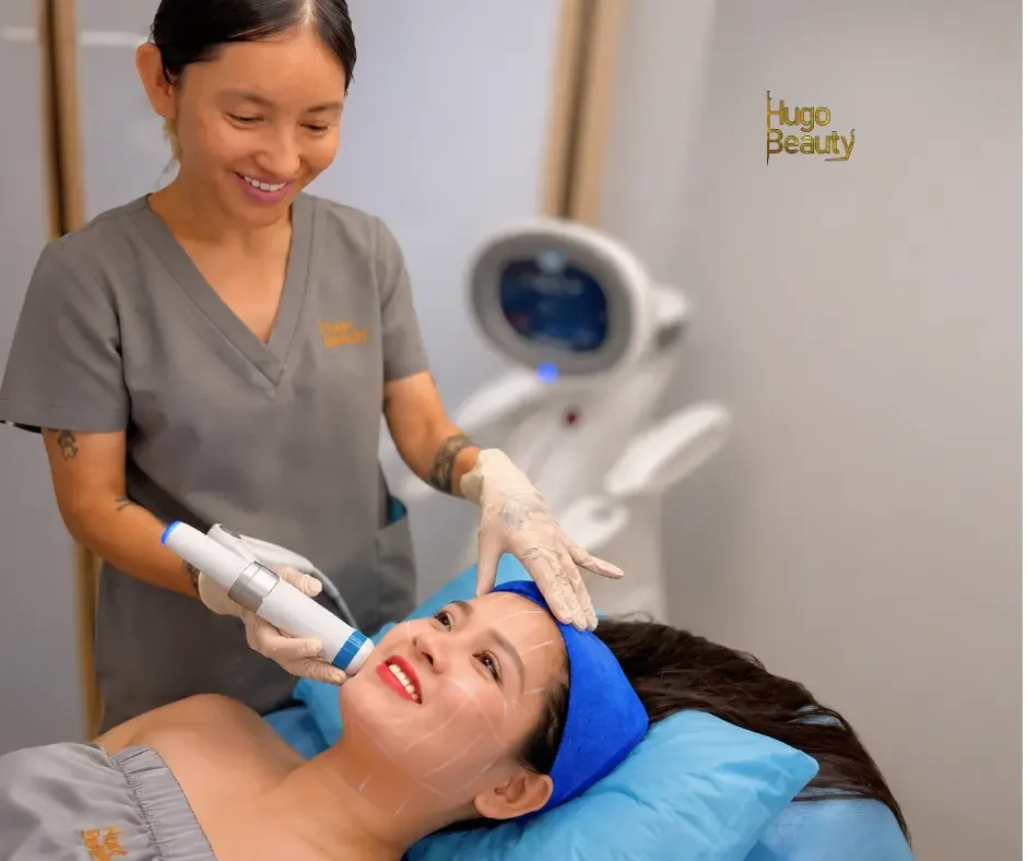 Founder of Hugo Beauty performing a HIFU facial treatment on a client in Ho Chi Minh City