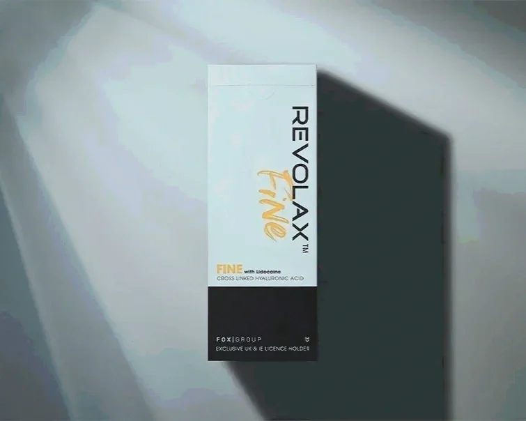 A box of REVOLAX fine dermal filler with lidocaine, positioned on a surface with shadowing.