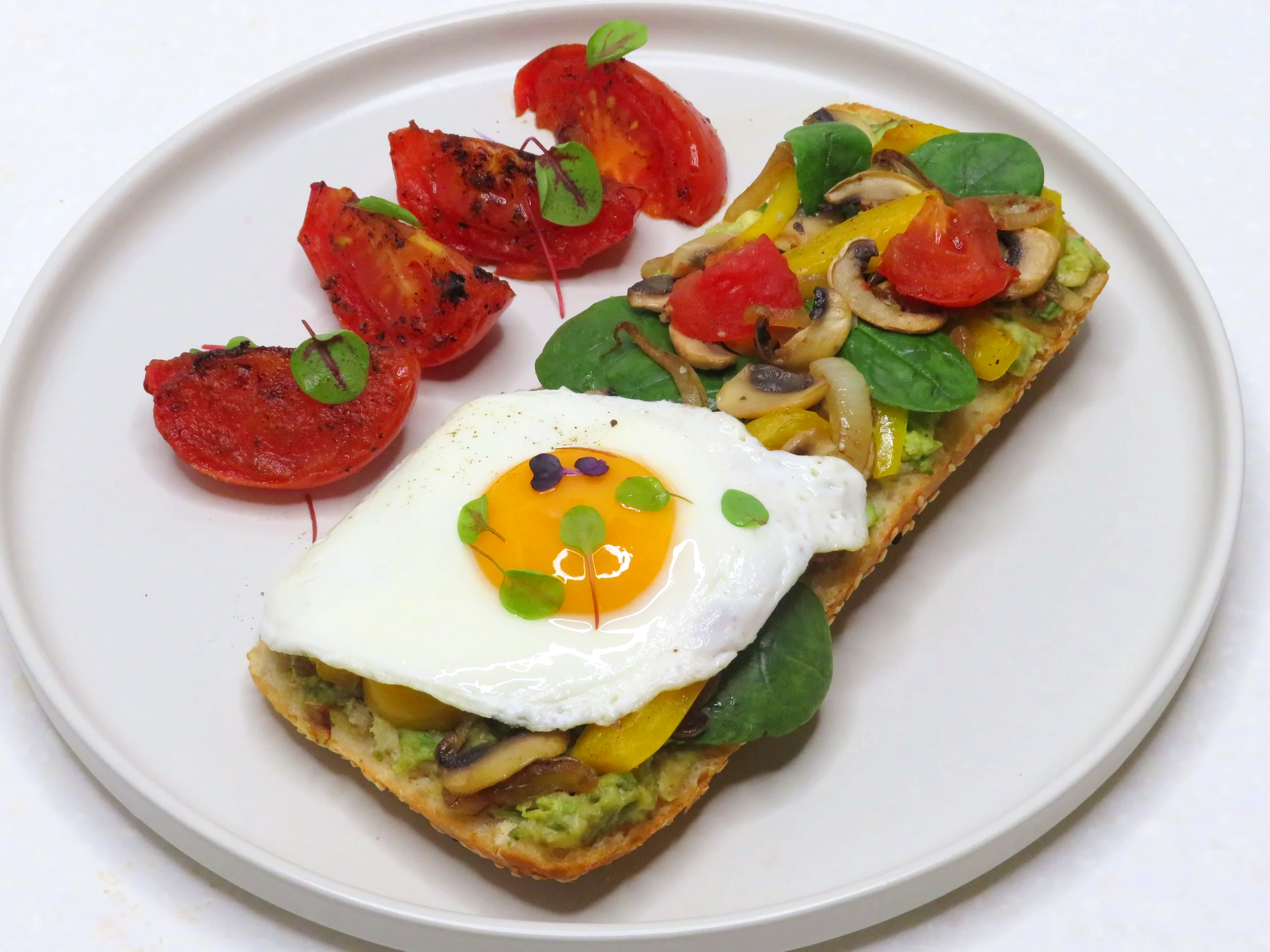 Egg on avocado toast with sauteed vegetables